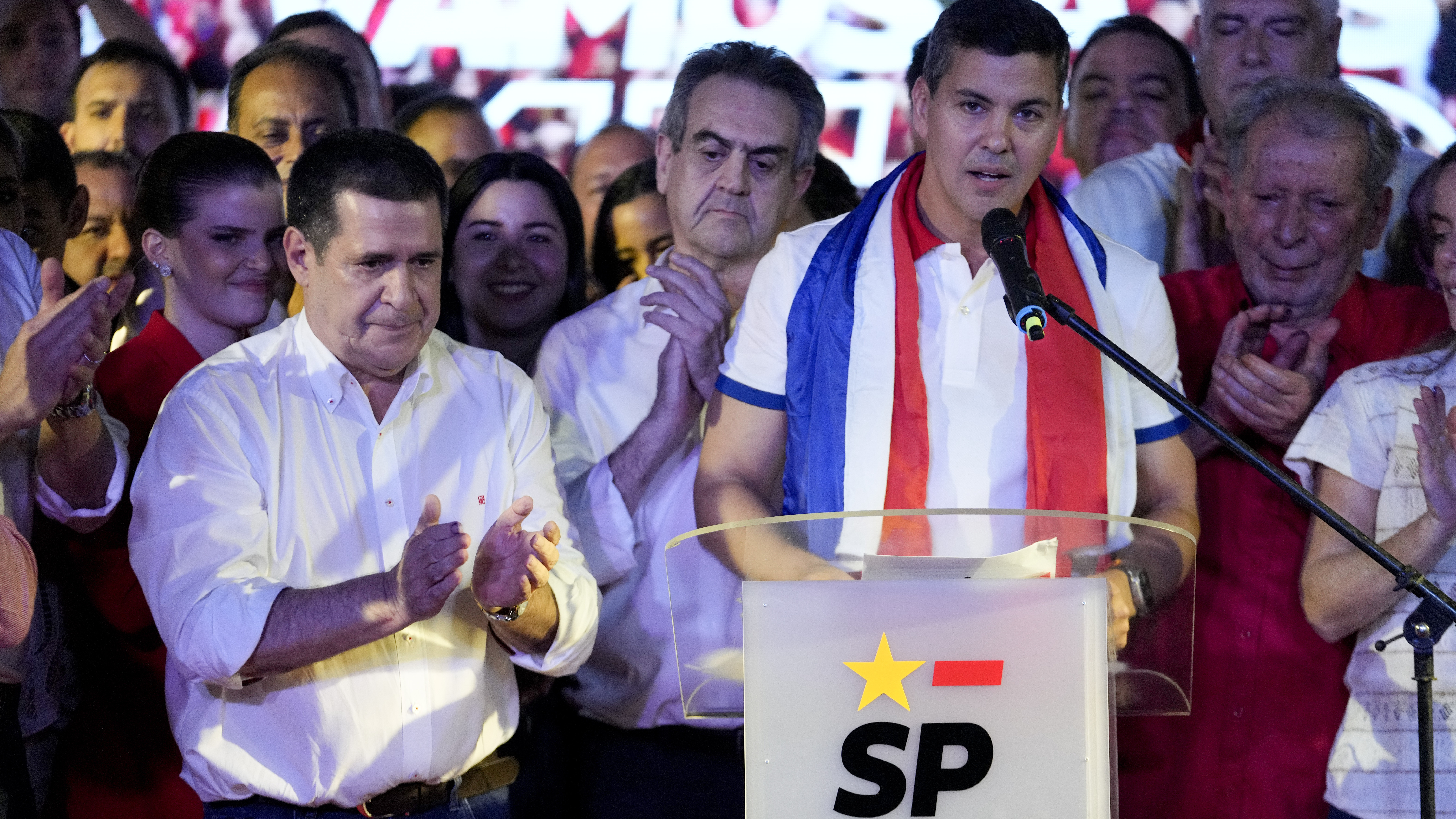 Santiago Peña, presidential candidate of the Colorado ruling party, right, talks beside former President Horacio Cartes after the voting closed during general elections in Asuncion, Paraguay, Sunday, April 30, 2023.