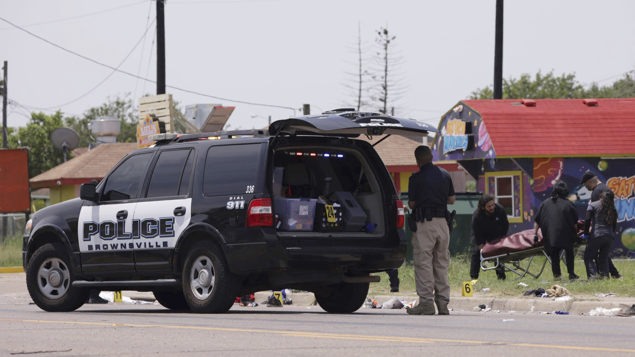 Emergency personnel respond to a fatal collision in Brownsville, Texas, on Sunday. Several people were killed after they were struck by a vehicle while waiting at a bus stop near Ozanam Center, a migrant and homeless shelter.