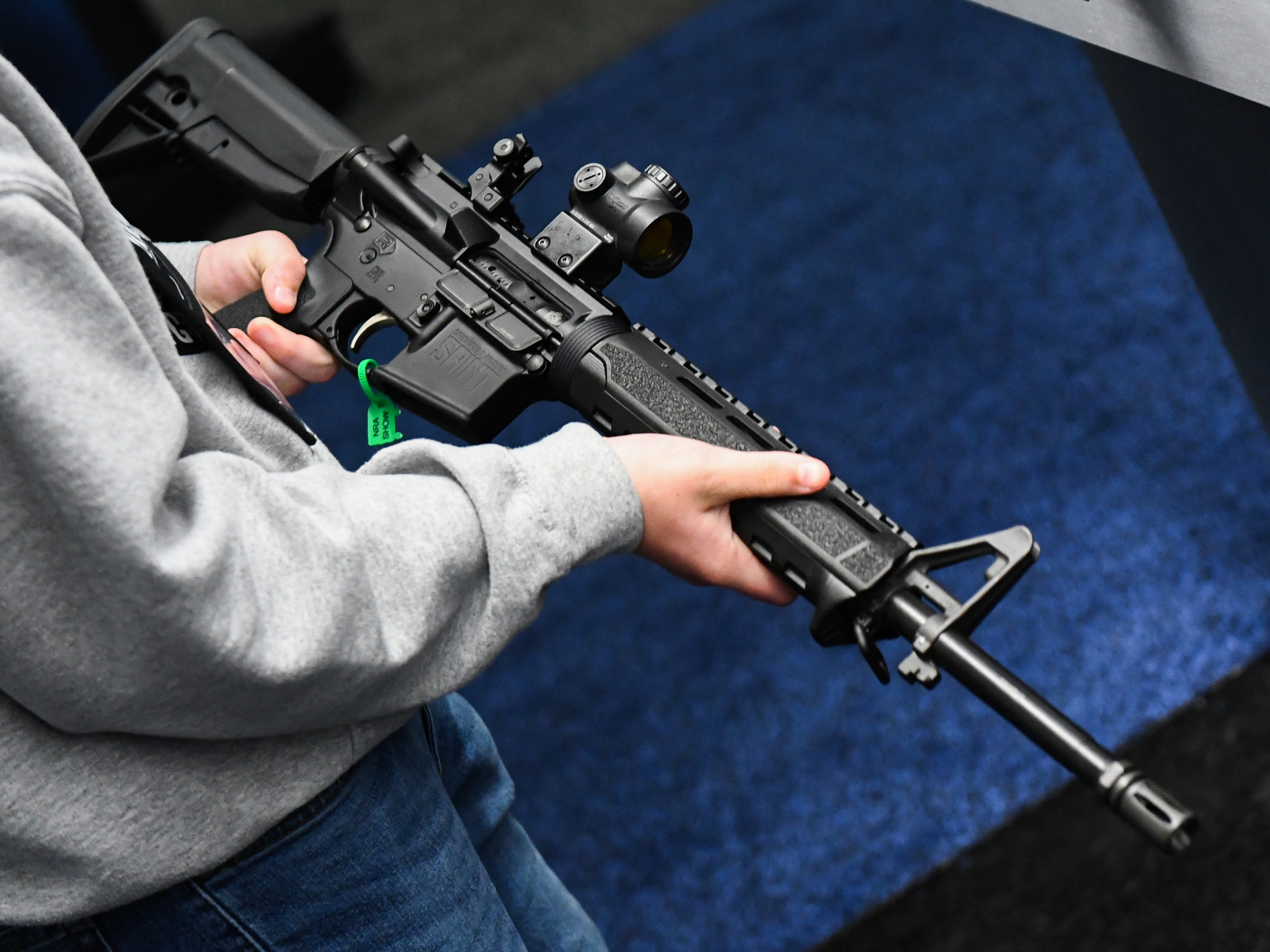 An attendee holds a Springfield Armory SAINT AR-15-style rifle displayed during the National Rifle Association Annual Meeting in Houston in 2022. (AFP via Getty Images)