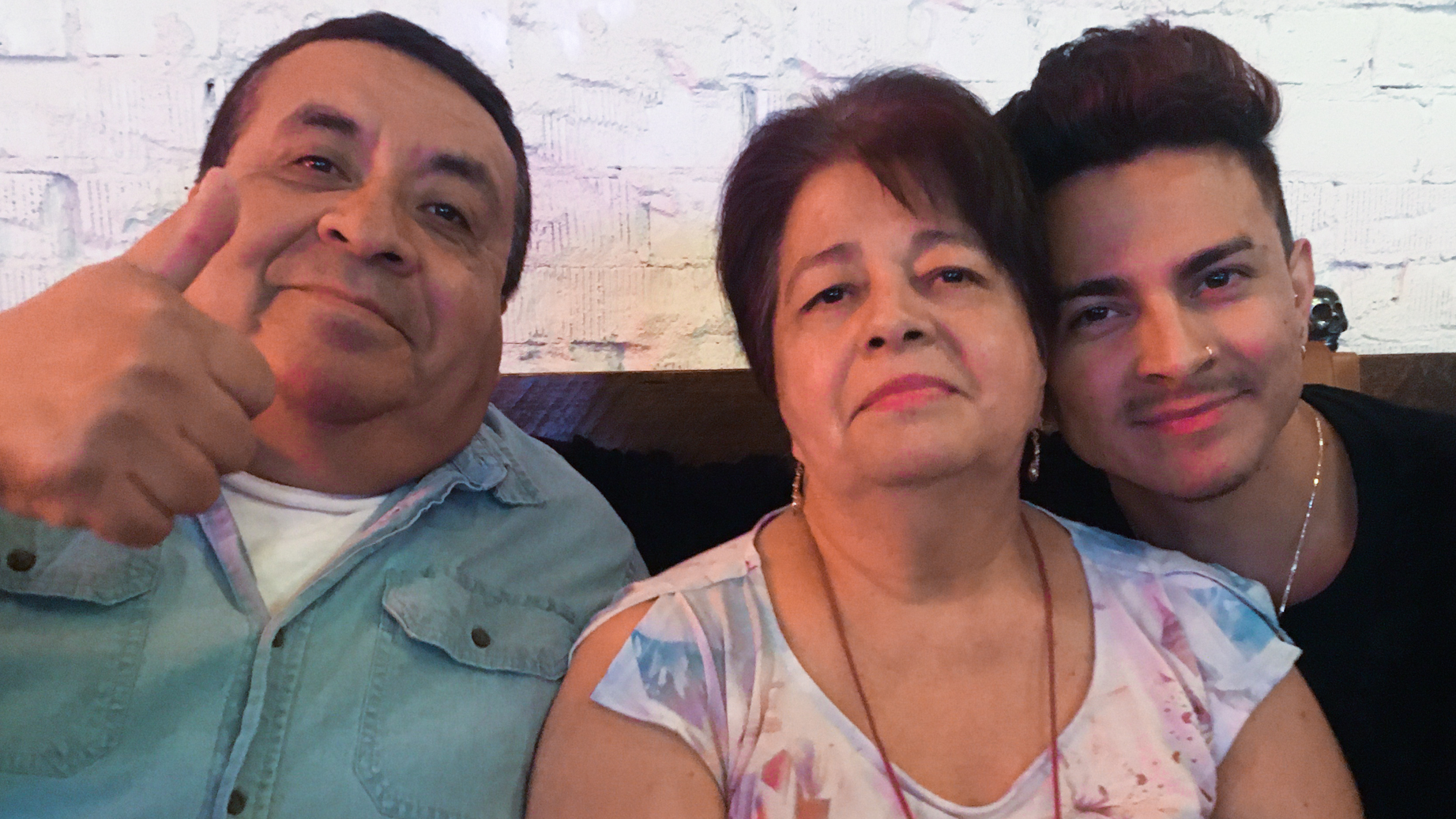 Miguel Lerma, right, with his grandparents who raised him, Jose and Virginia Aldaco.