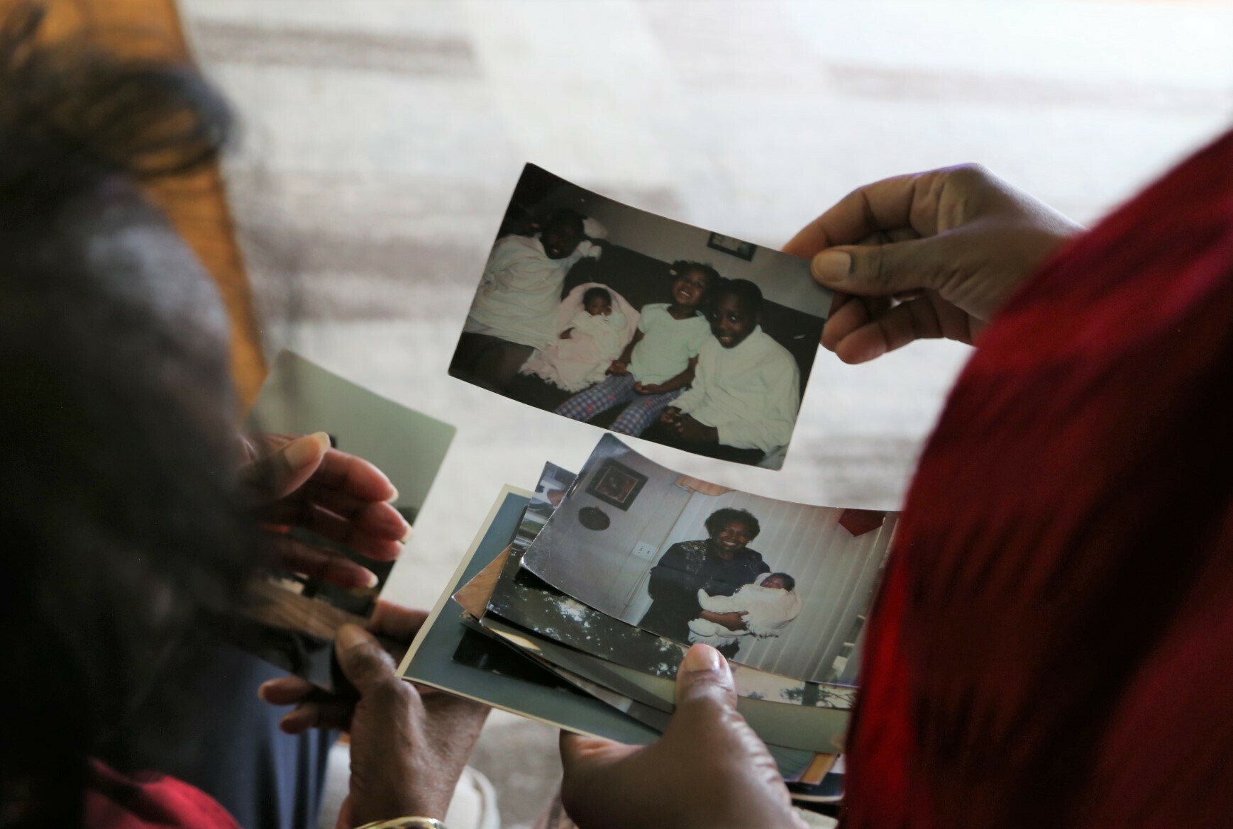 Reynolds and Lewis-Thorpe look through family photos together. Reynolds says she missed the initial signs of her mom's Alzheimer's because they lived in different cities.
