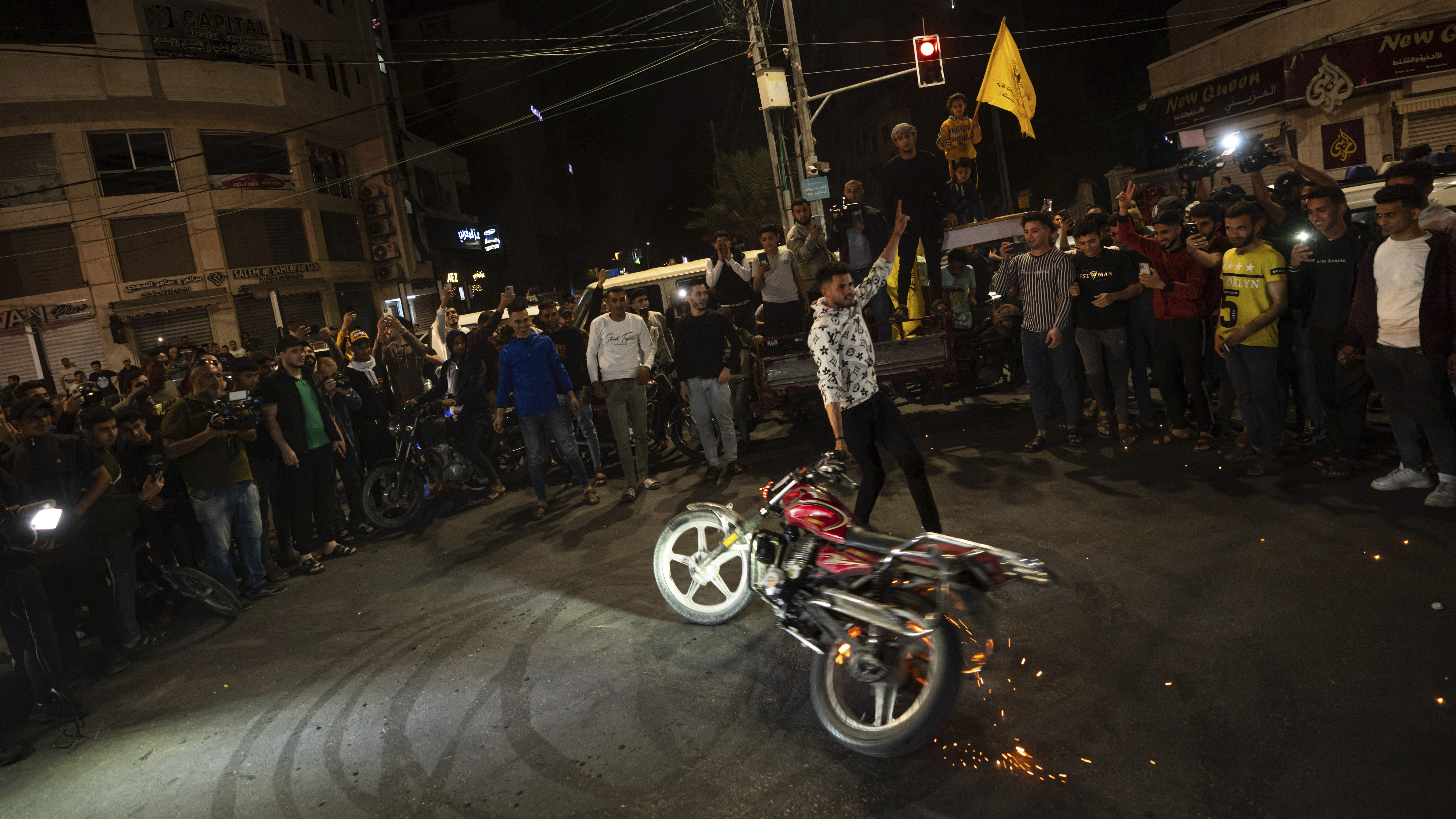 Palestinians celebrate the announcement of a cease-fire after five days of fighting between Israel and the Islamic Jihad militant group in Gaza City, on Saturday.