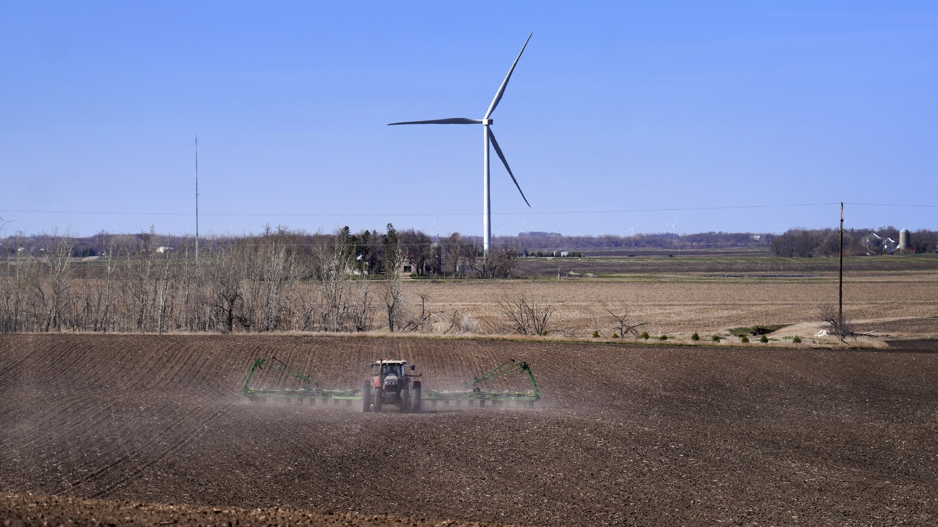 Corn is planted with a view of wind turbines on April 2, in Lake Benton, Minn. The U.S. Department of Agriculture announced a nearly $11 billion investment on Tuesday to help bring affordable clean energy to rural communities throughout the country.