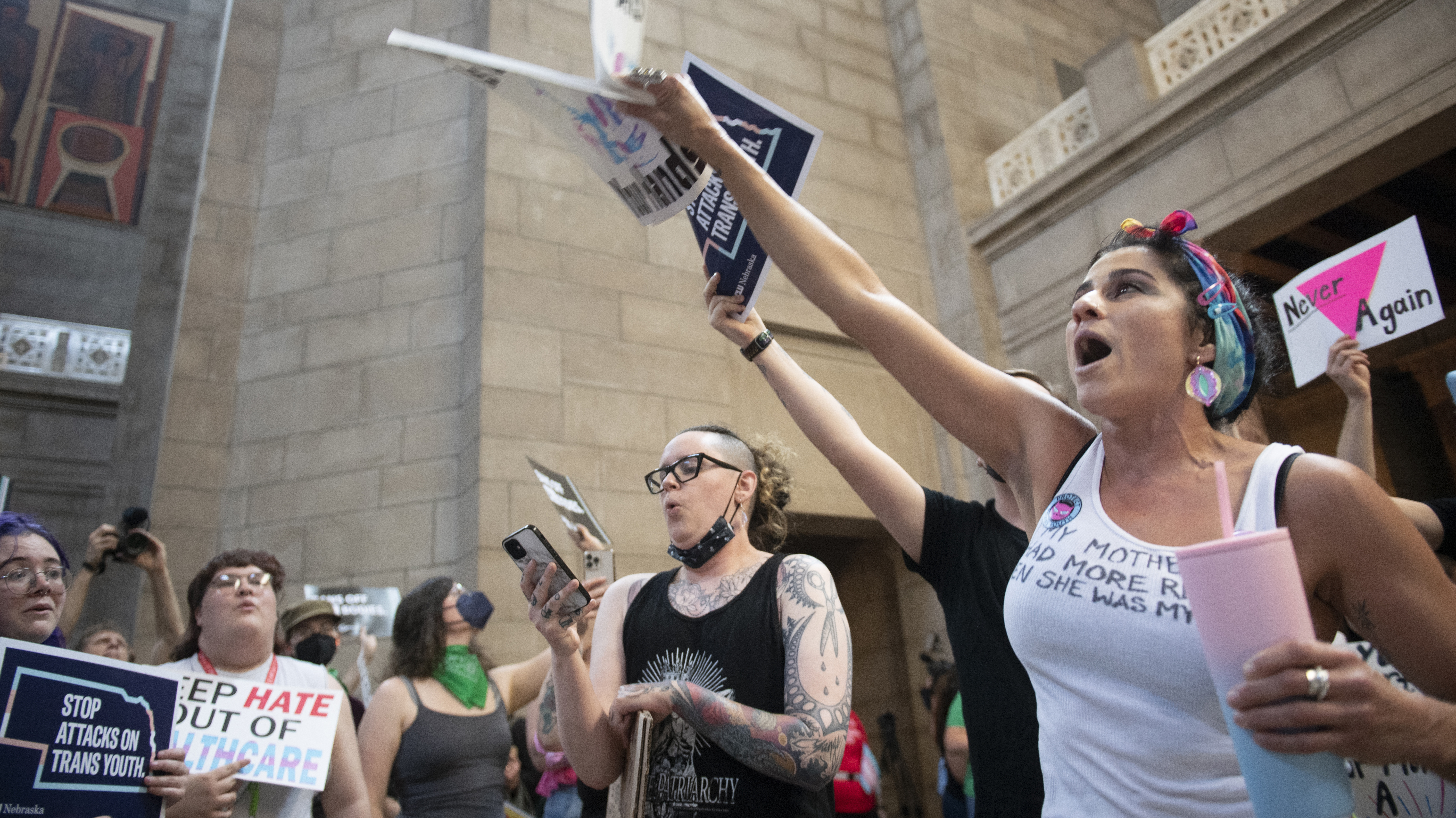 Juju Tyner of Lincoln, right, leads the singing of "Over the Rainbow" during the protest of LB 574, which limits gender-affirming care for trans youth, on Friday, May 19, 2023, in Lincoln, Neb.