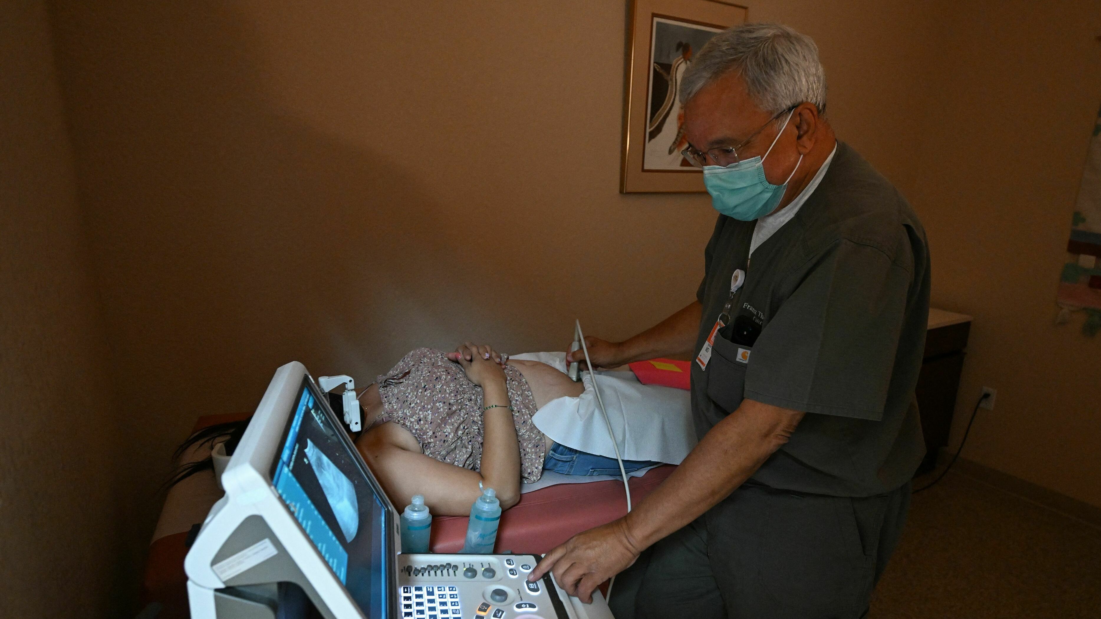 Dr. Franz Theard performs a sonogram on a patient seeking abortion services at the Women