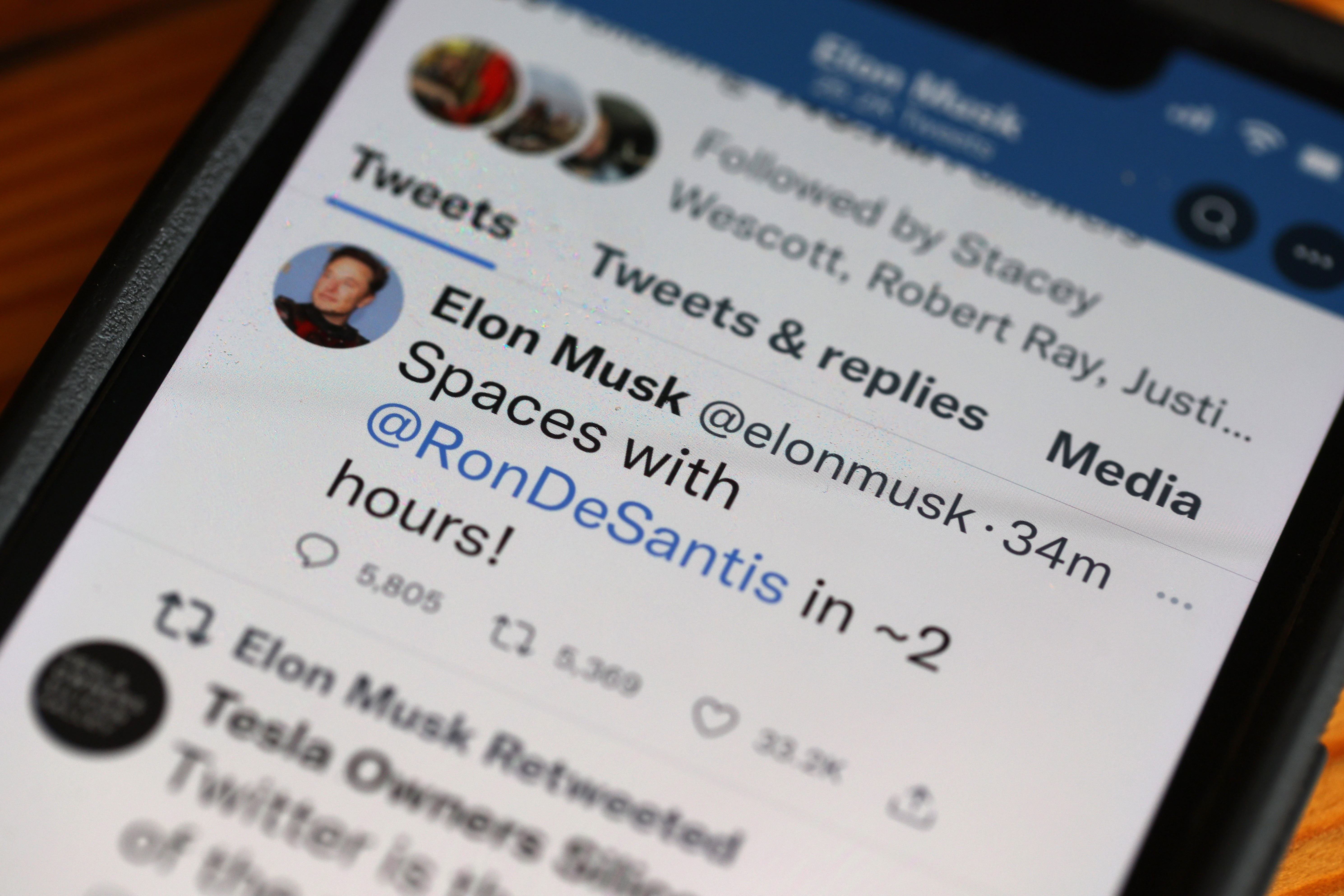 In this photo illustration, businessman and Twitter owner Elon Musk tweets about a Twitter Spaces event he will be hosting with Florida Gov. Ron DeSantis on May 24. (Getty Images)