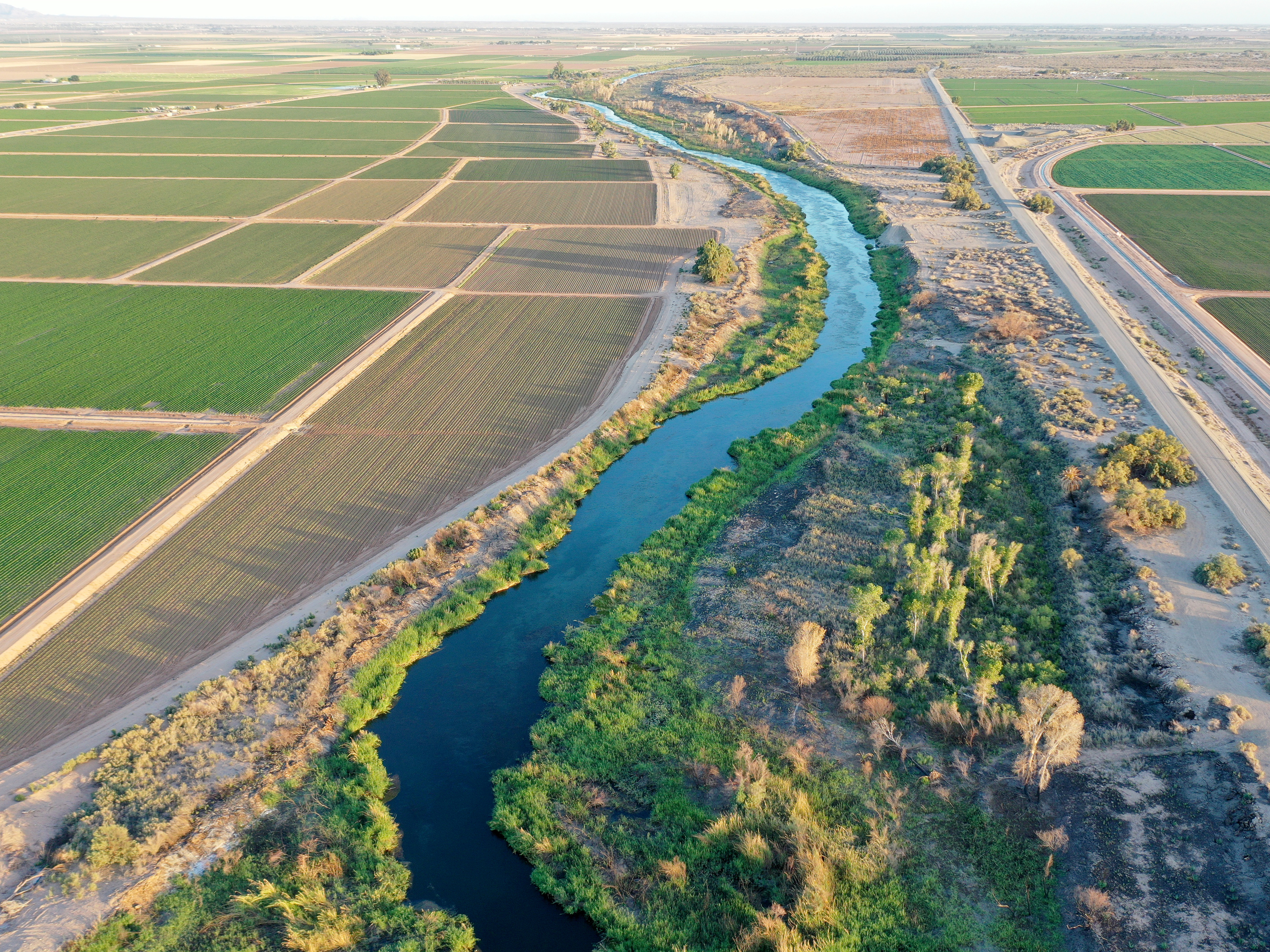 An aerial view of the long-depleted Colorado River, currently swollen by winter snowmelt water, as it flows past farmland along the border between California (R) and Arizona on May 25, 2023 near Yuma, Arizona. (Getty Images)