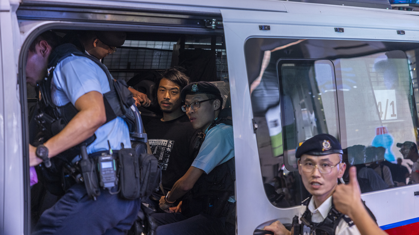 China tightens access to Tiananmen Square while 32 are detained in Hong Kong
