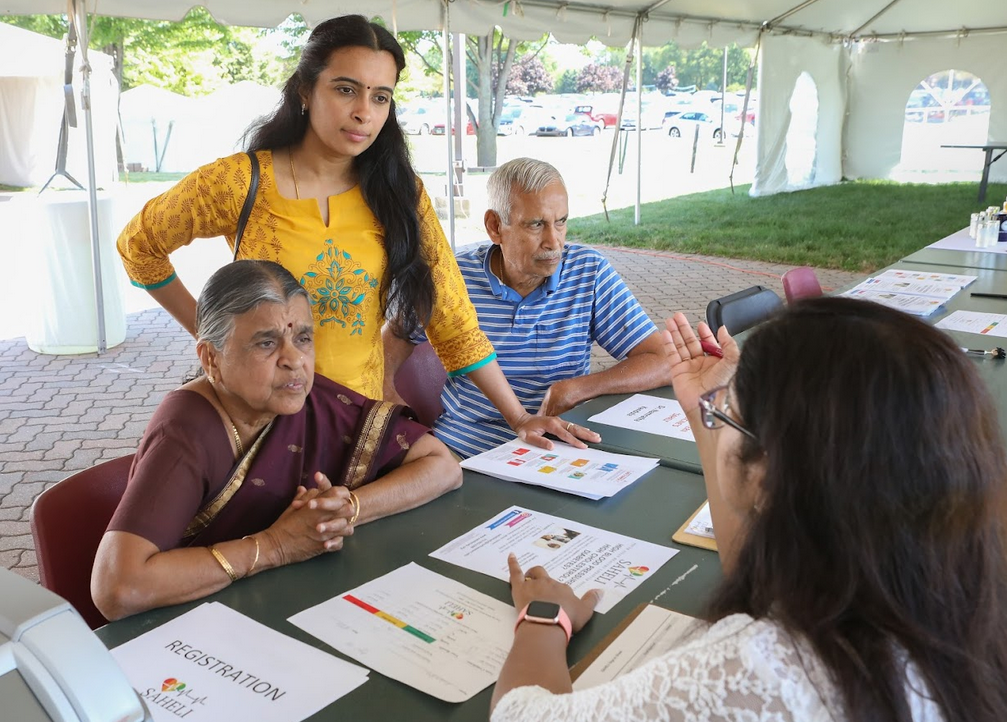 Attendees at a health fair at the  Balaji Temple, in Aurora, Ill., learn about the SAHELI diabetes prevention program. (Teresa Crawford/Northwestern University)