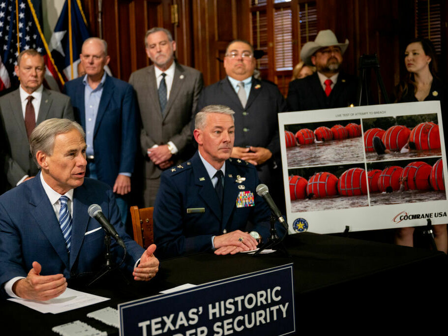 Texas Gov. Greg Abbott (left) speaks about a new border security measure during a news conference at the Texas State Capitol on June 8. (Getty Images)
