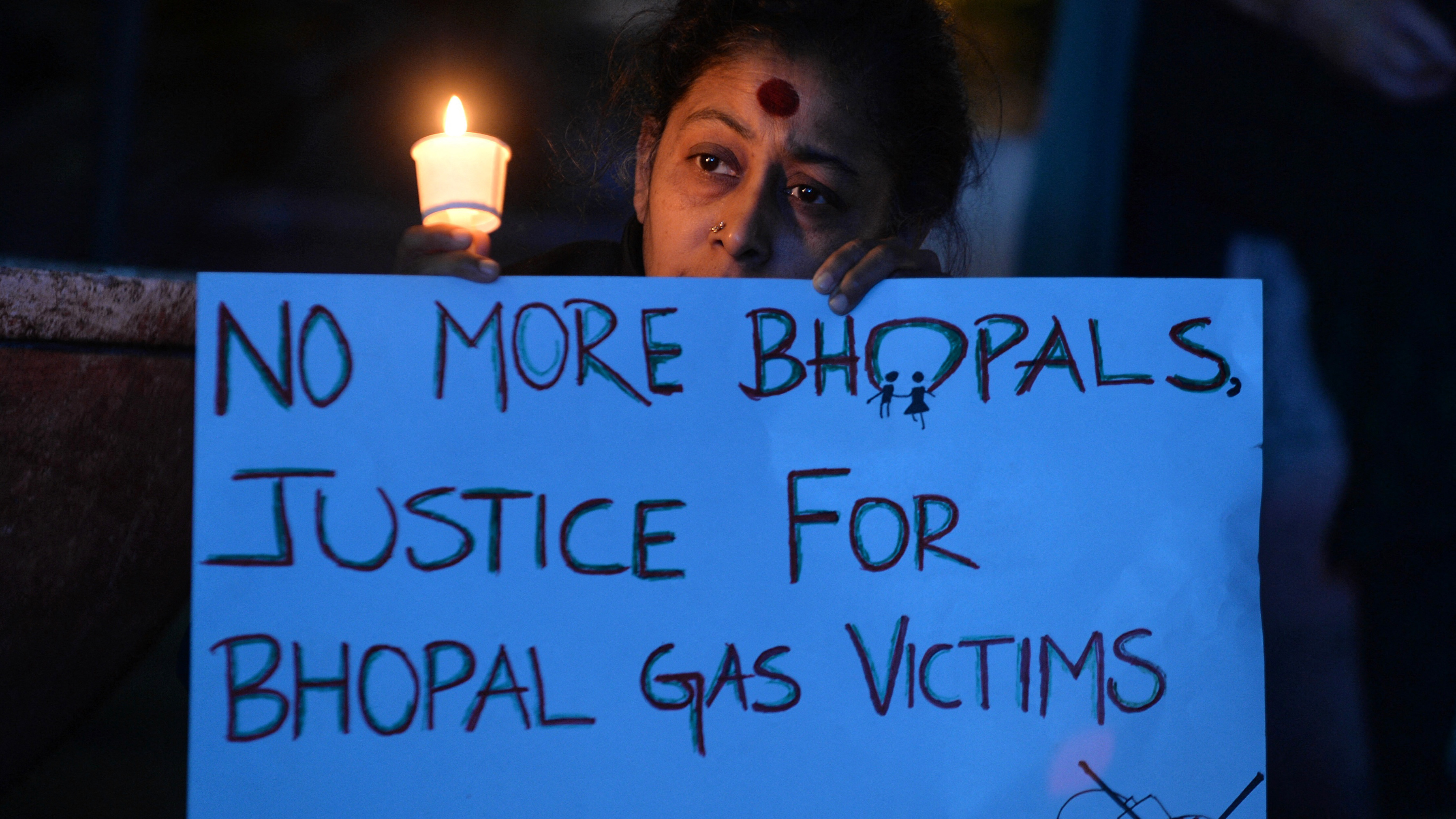 Members of the Bengaluru Solidarity Group in Support of the Bhopal Struggle take part in a candlelight vigil to commemorate the 30th anniversary of the Bhopal gas disaster in Bangalore on December 2, 2014.