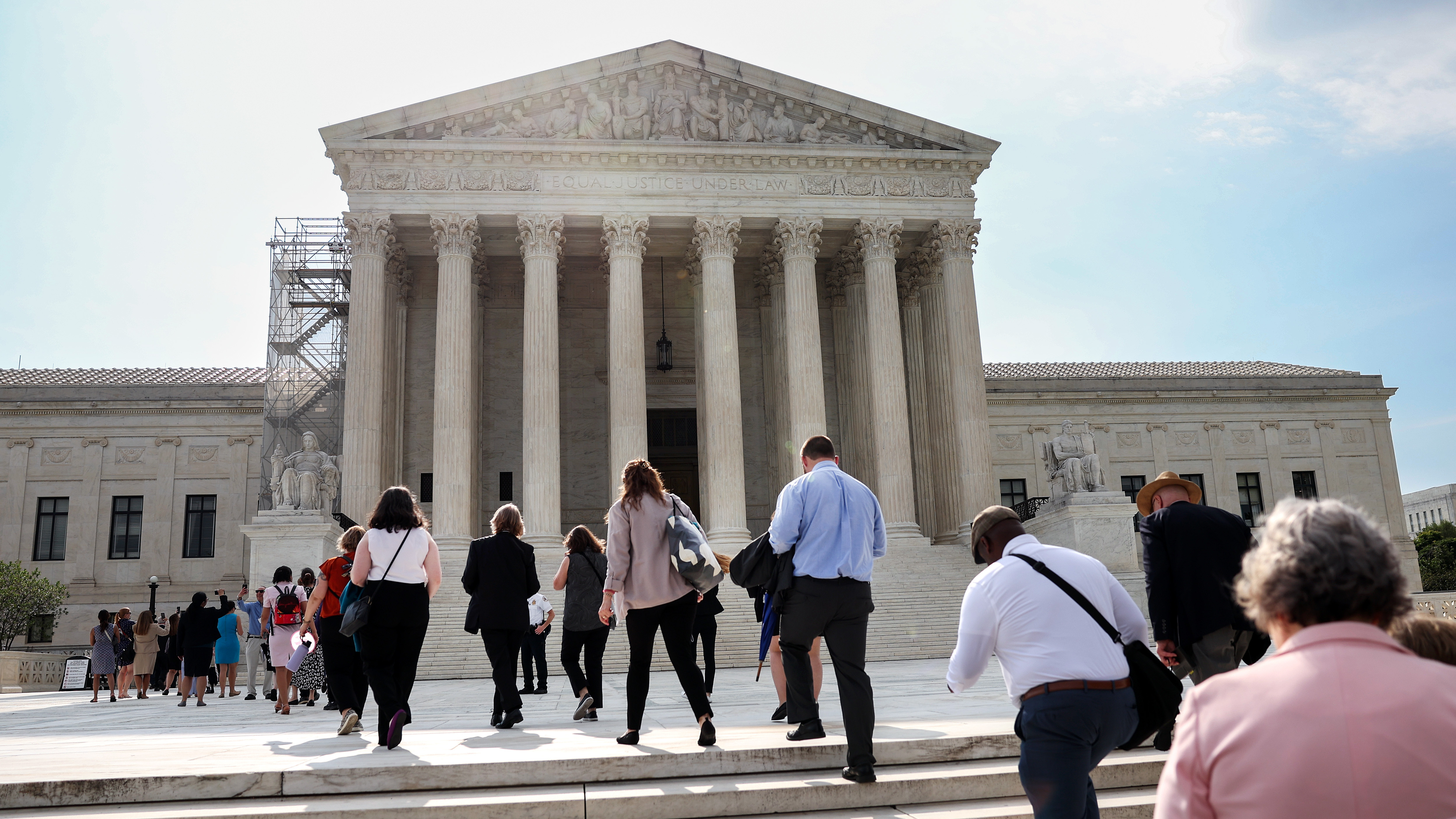 People walk into the U.S. Supreme Court in Washington, D.C., on Tuesday, the day that the court's majority rejected the once-fringe idea that state legislatures' power over congressional elections cannot be checked or balanced by state constitutions or state courts. (Getty Images)