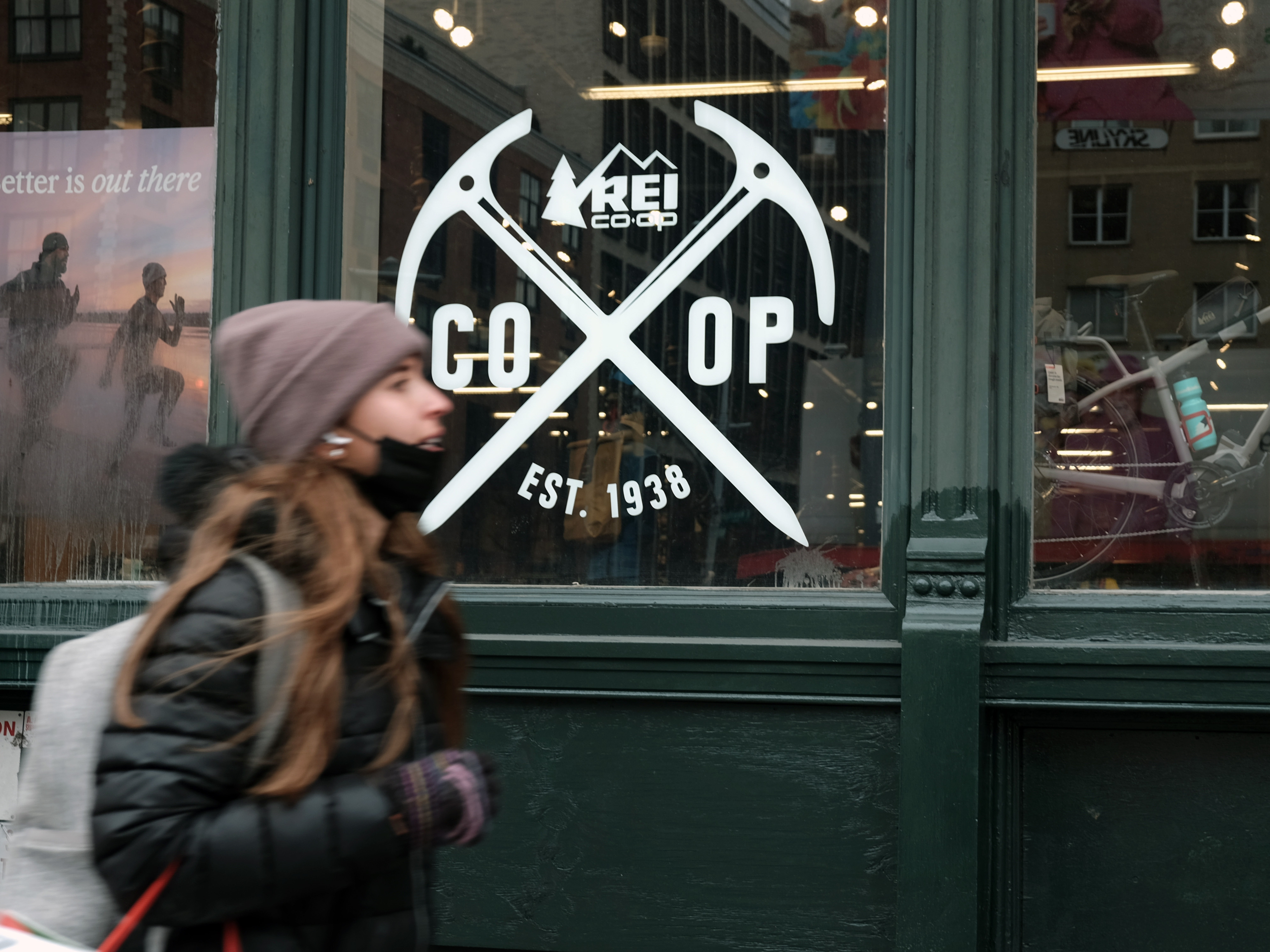 A pedestrian walks by REI's flagship store in New York, where last year workers formed the company's first union. (Getty Images)