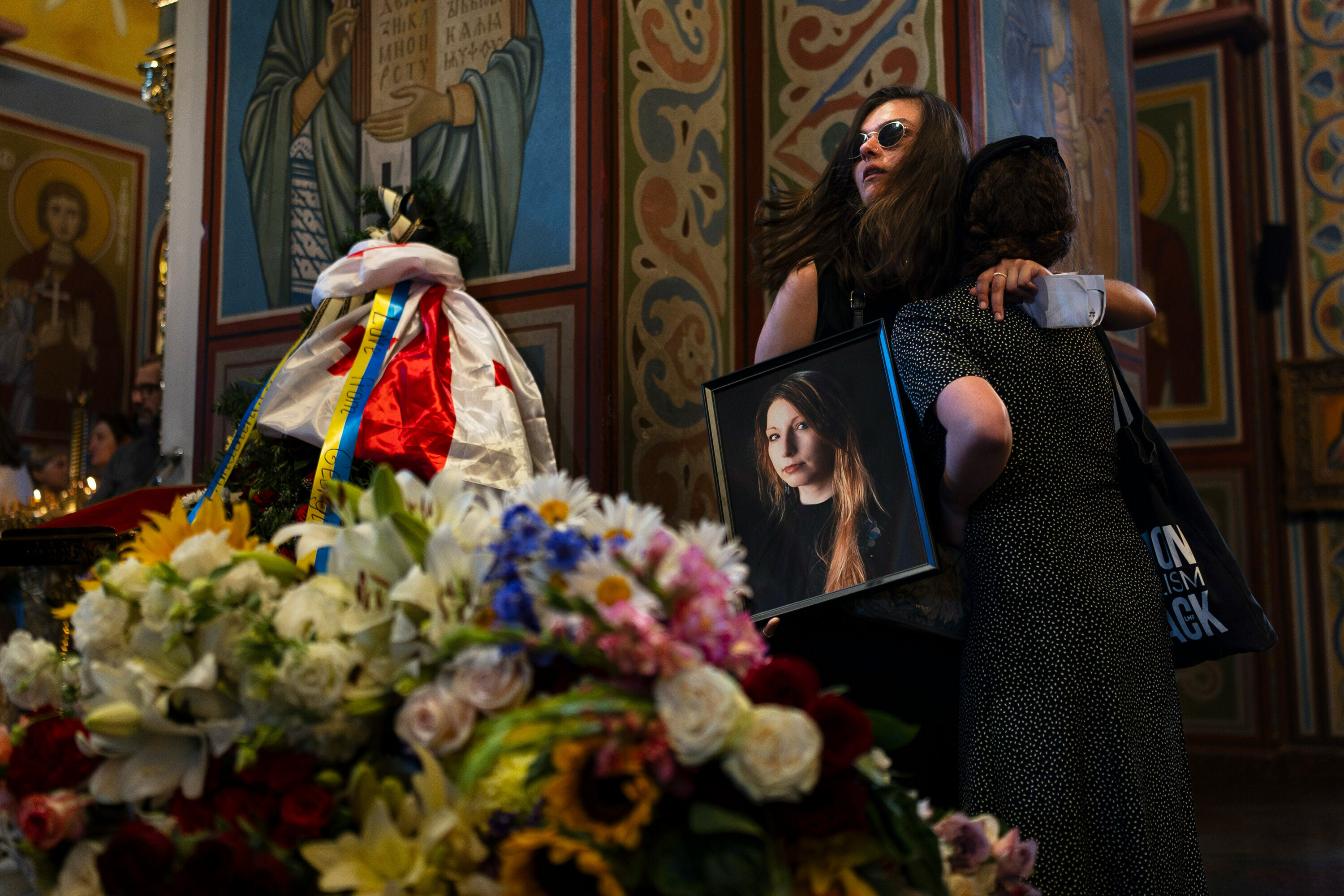 She saved the diary of a Ukrainian writer killed by Russia. Then she was killed, too 8 Holding a photo of Ukrainian writer Victoria Amelina, Sofia Cheliak hugs a woman during a memorial service for Amelina in Kyiv, Ukraine, on July 4. The award-winning writer died from her injuries after the June 27 Russian missile strike on a popular restaurant frequented by journalists and aid workers in eastern Ukraine.