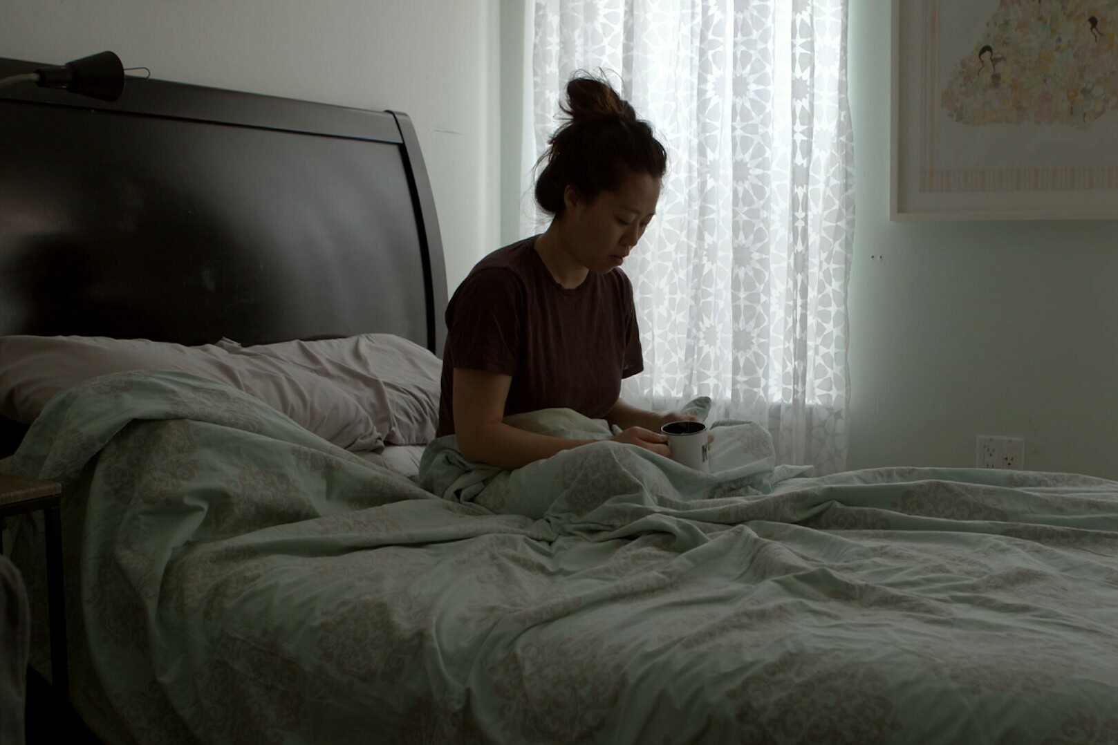 In this still from Below the Belt, Kyung Jeon-Miranda, a Brooklyn-based artist, has a reflective moment. She is still trying to get pregnant despite the impact of endometriosis on her fertility.