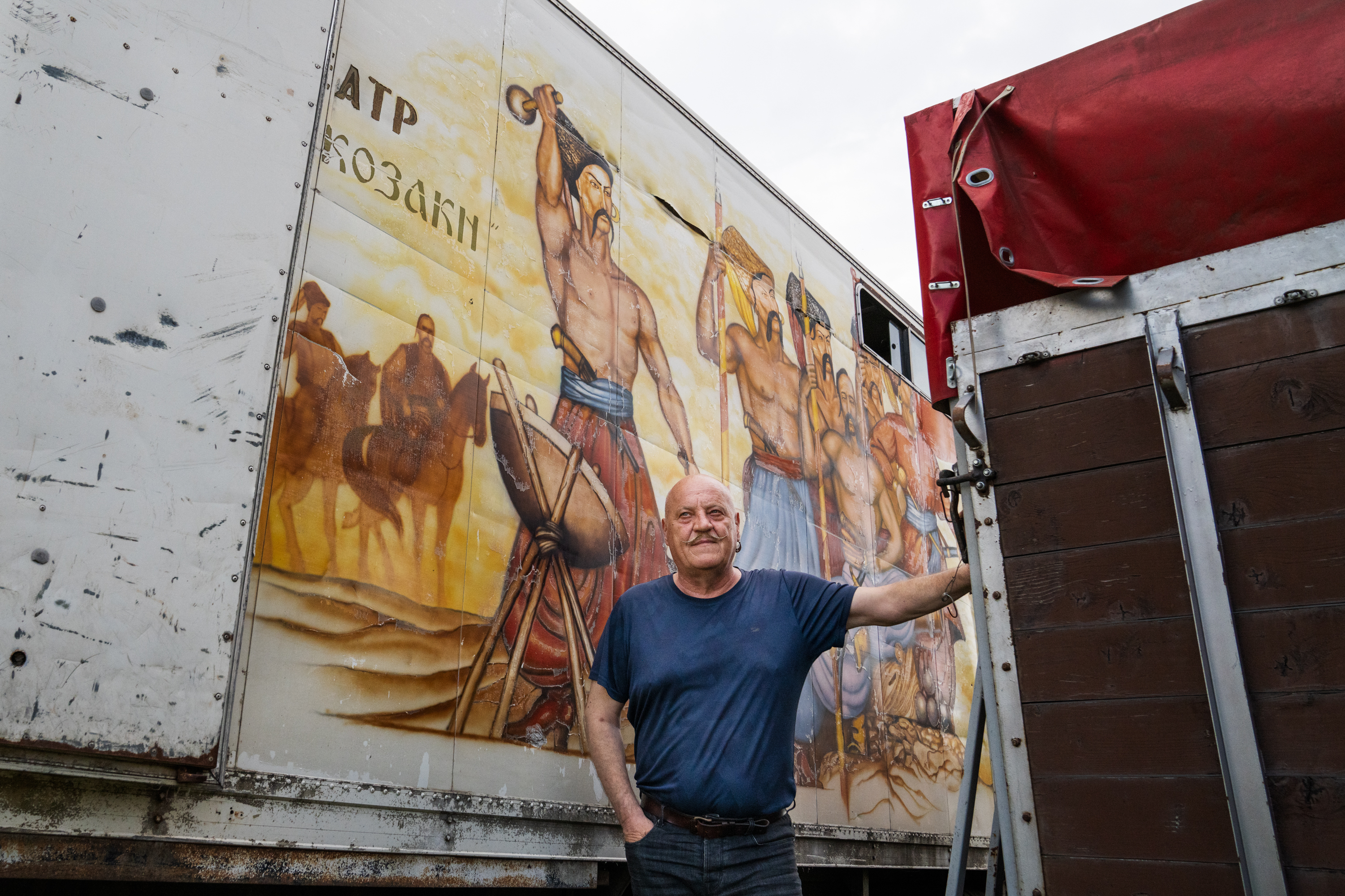 The Cossacks' traditions live on near the front lines in Ukraine 3 Kopishinskyi stands in front of a mural depicting Cossacks with long mustaches painted on the side of a trailer that they once used to transport horses to shows.