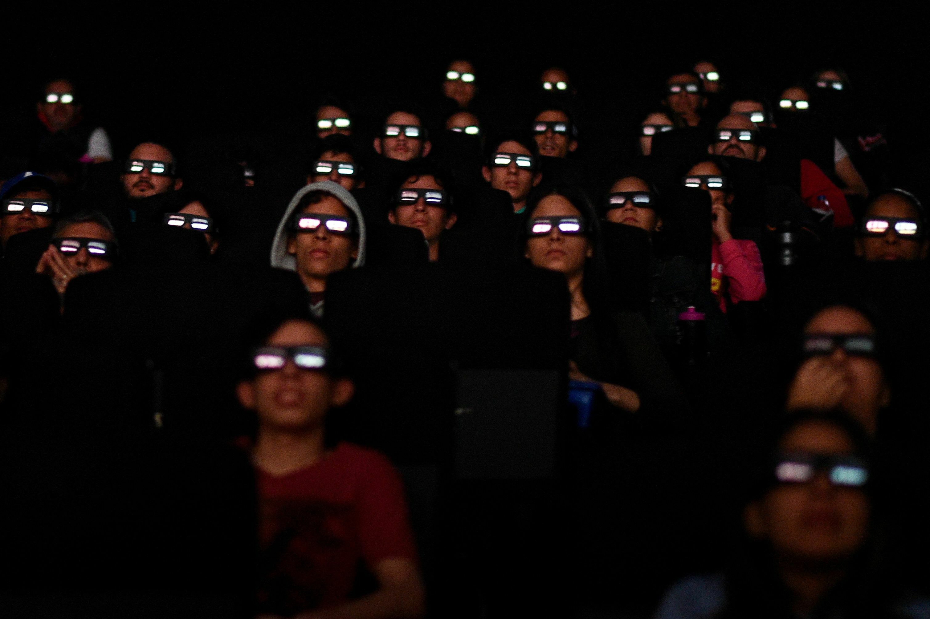 Filmgoers watch a screening of Marvel Studios' <em>Avengers: Endgame</em> at a cinema in Caracas in April 2019. More than 50 workers at Marvel Studios in LA, New York and Atlanta have signed authorization cards to be represented by the International Alliance of Theatrical Stage Employees, or IATSE. (AFP via Getty Images)