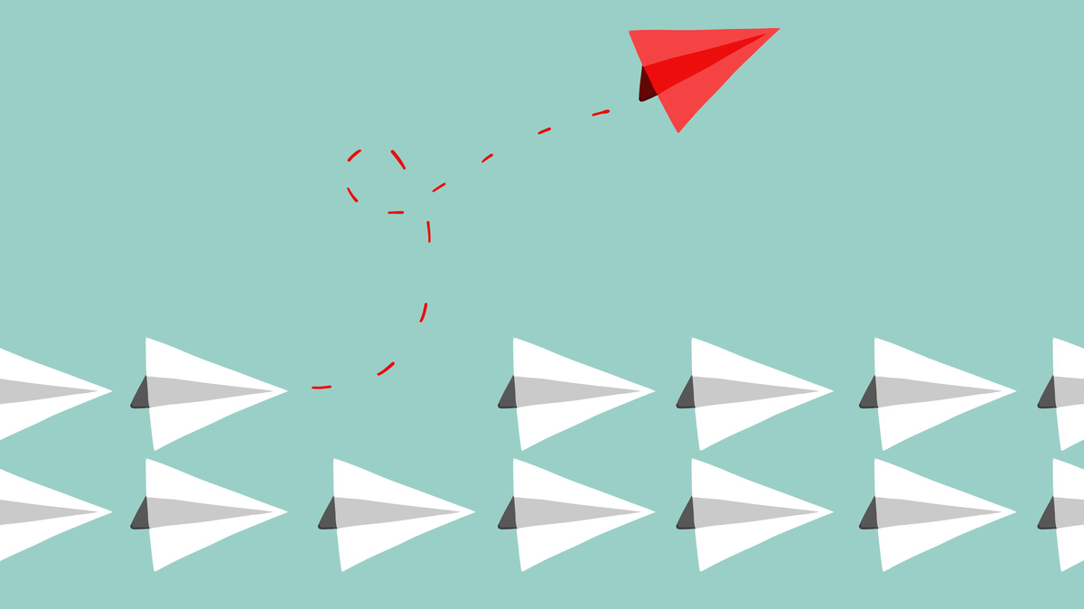 Two rows of white paper airplanes fly in a straight line. One red airplane flies away from the rows with a twirling red dotted line in its wake, to signify breaking from work culture.