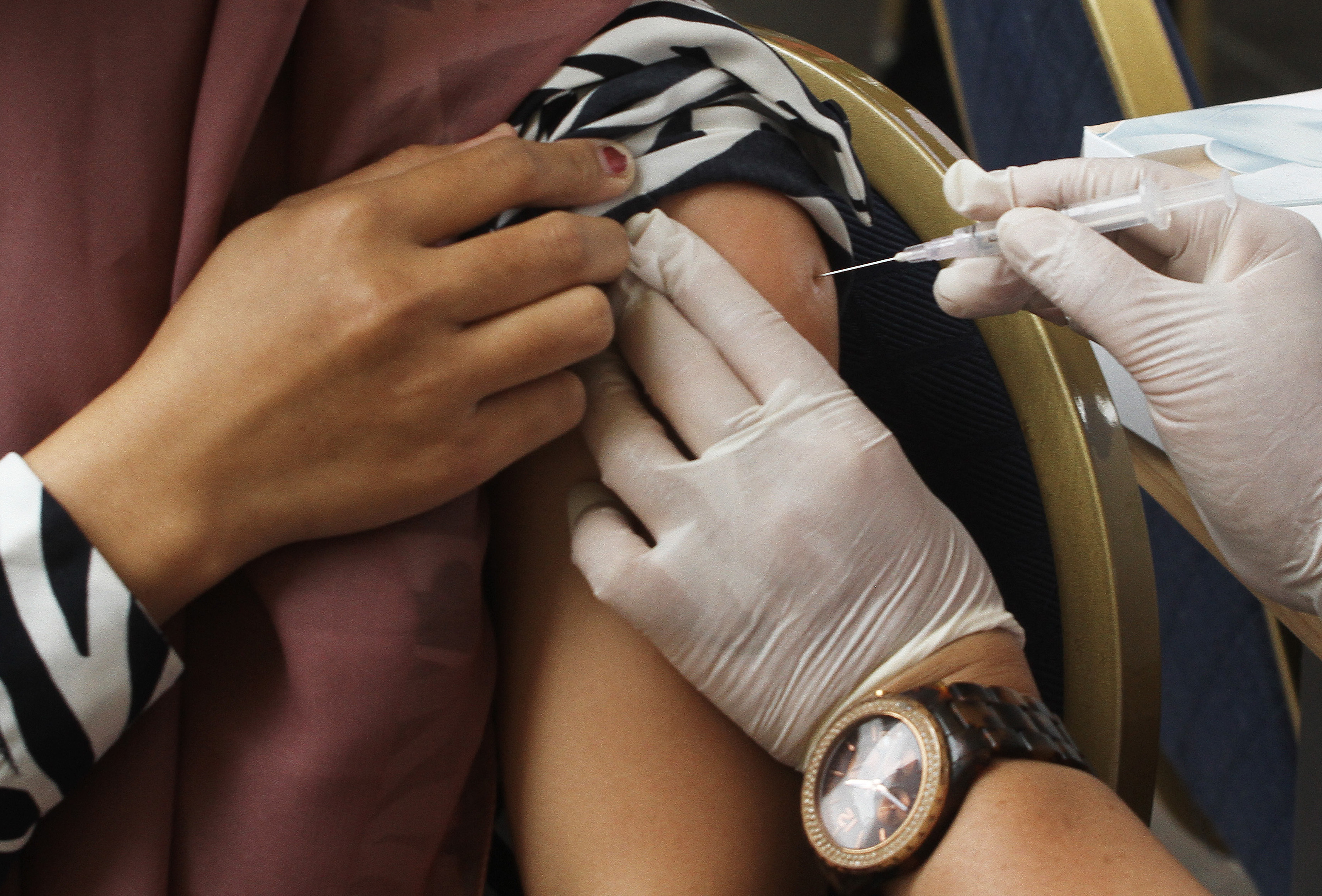 A COVID booster is administered in Jakarta, Indonesia. (Anadolu Agency via Getty Images)