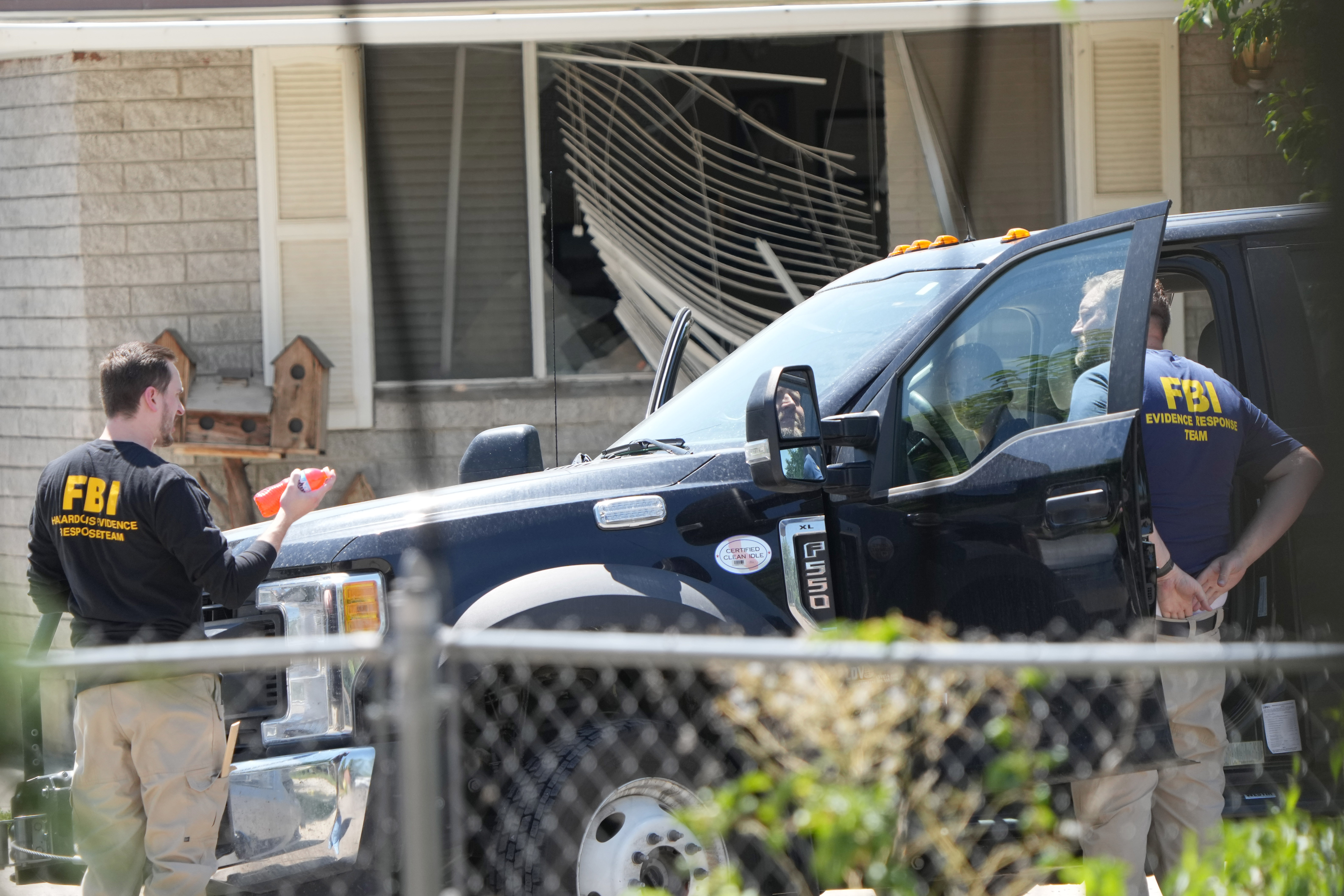 FBI agents process the home of Craig Robertson who was shot and killed by the FBI in a raid on his home on Wednesday in Provo, Utah. The FBI was investigating alleged threats by Robertson to President Biden ahead of the president's visit to the state this week. (Getty Images)