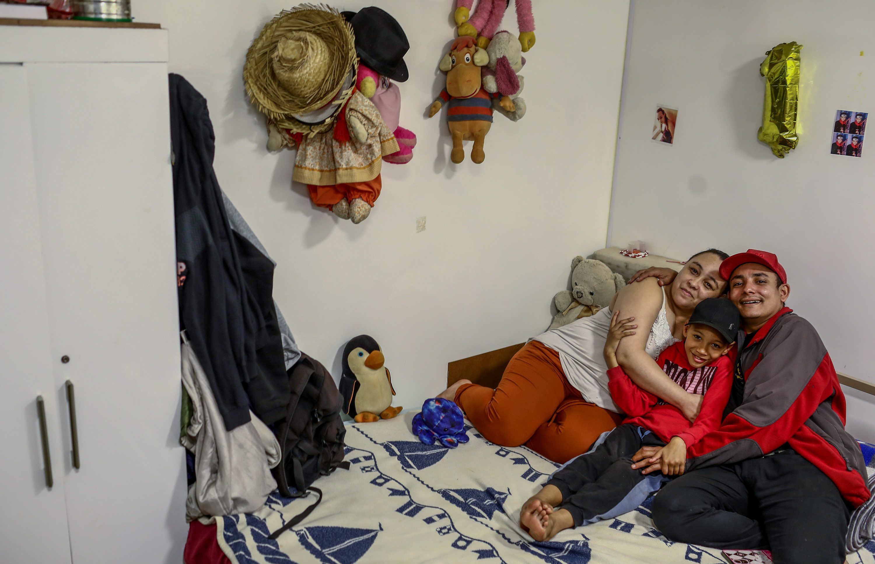 Erica Lacerda de Souza, Bruce Lee Sousa and son Henrique of São Paulo, Brazil, lost their home during the pandemic but got a fresh start from a program that offers tiny houses to homeless people. At first they said no — it seemed too good to be true. (Felipe Iruata for NPR)