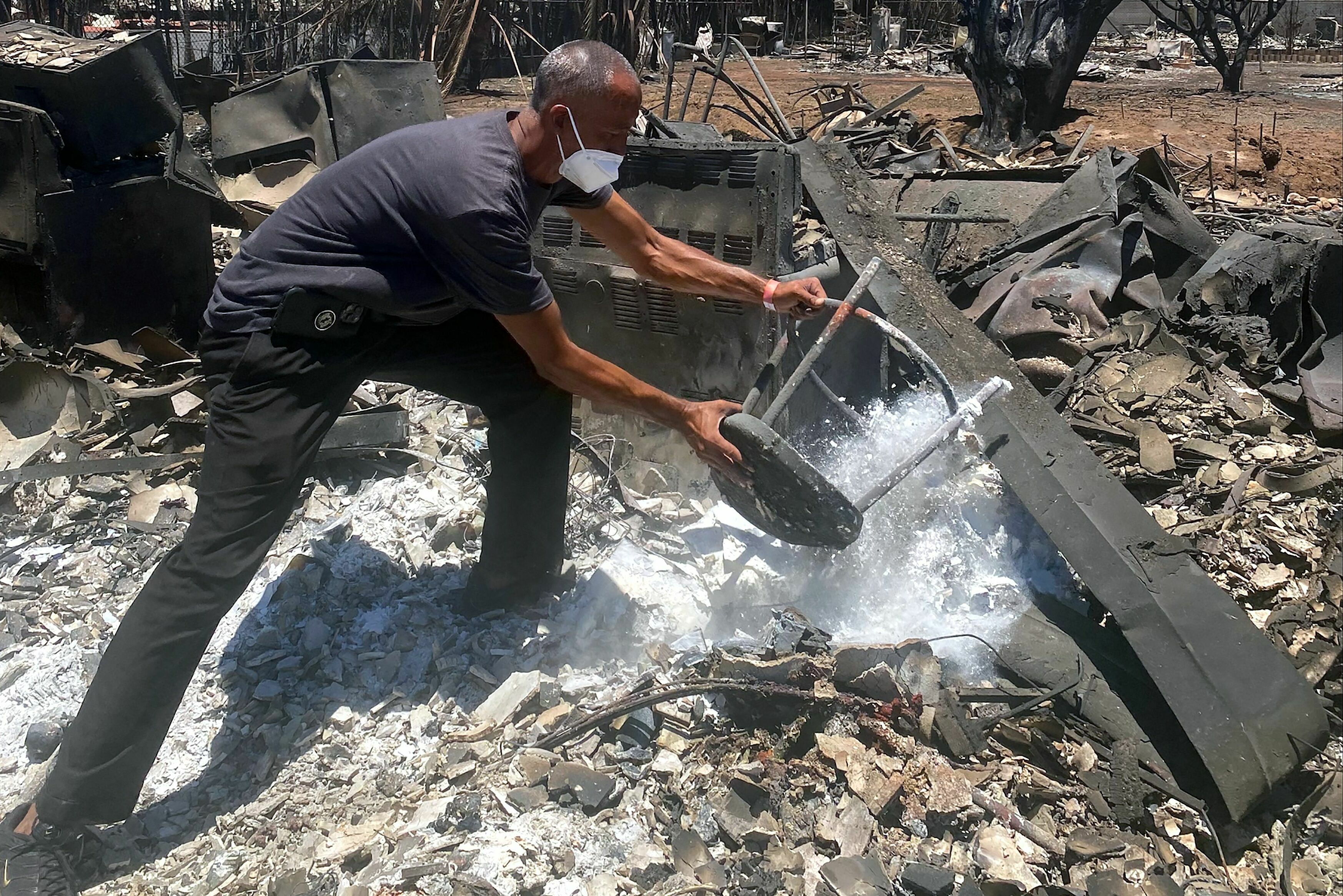 Anthony M. La Puente, 44, recovers items from his house in  Lahaina.
