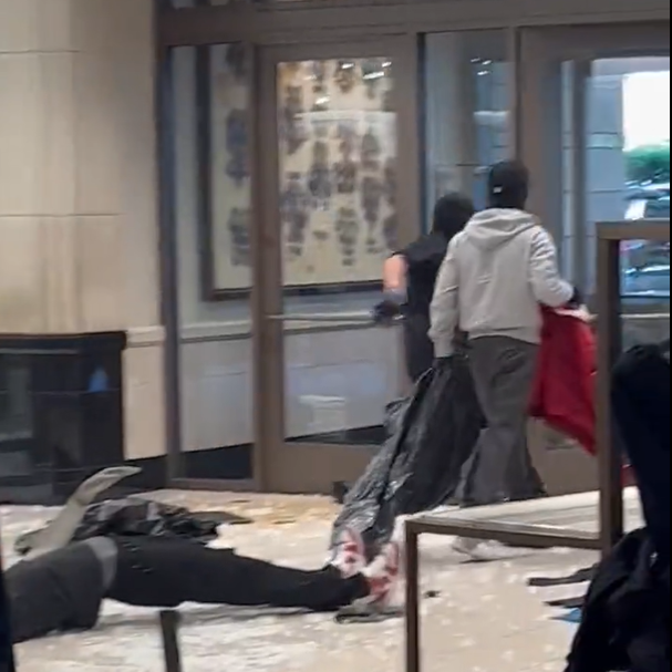 A screenshot of video posted by @noelskeez on X, formerly known as Twitter, shows masked robbers ransacking the department store in Topanga, Calif. (Screenshot by NPR)