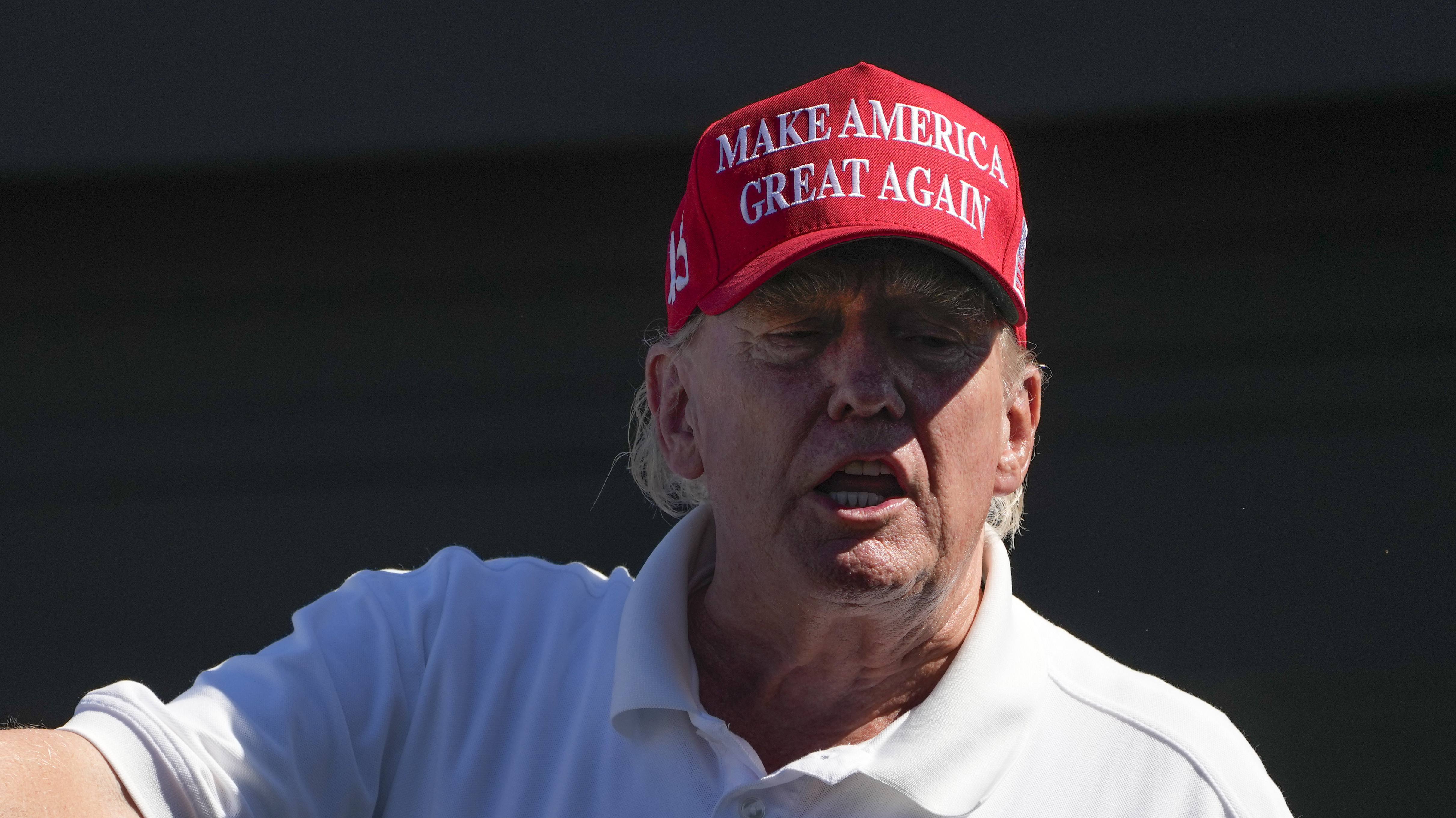 Former President Donald Trump talks to people in the crowd during the final round of the Bedminster Invitational LIV Golf tournament in Bedminster, N.J., Sunday, Aug. 13, 2023.