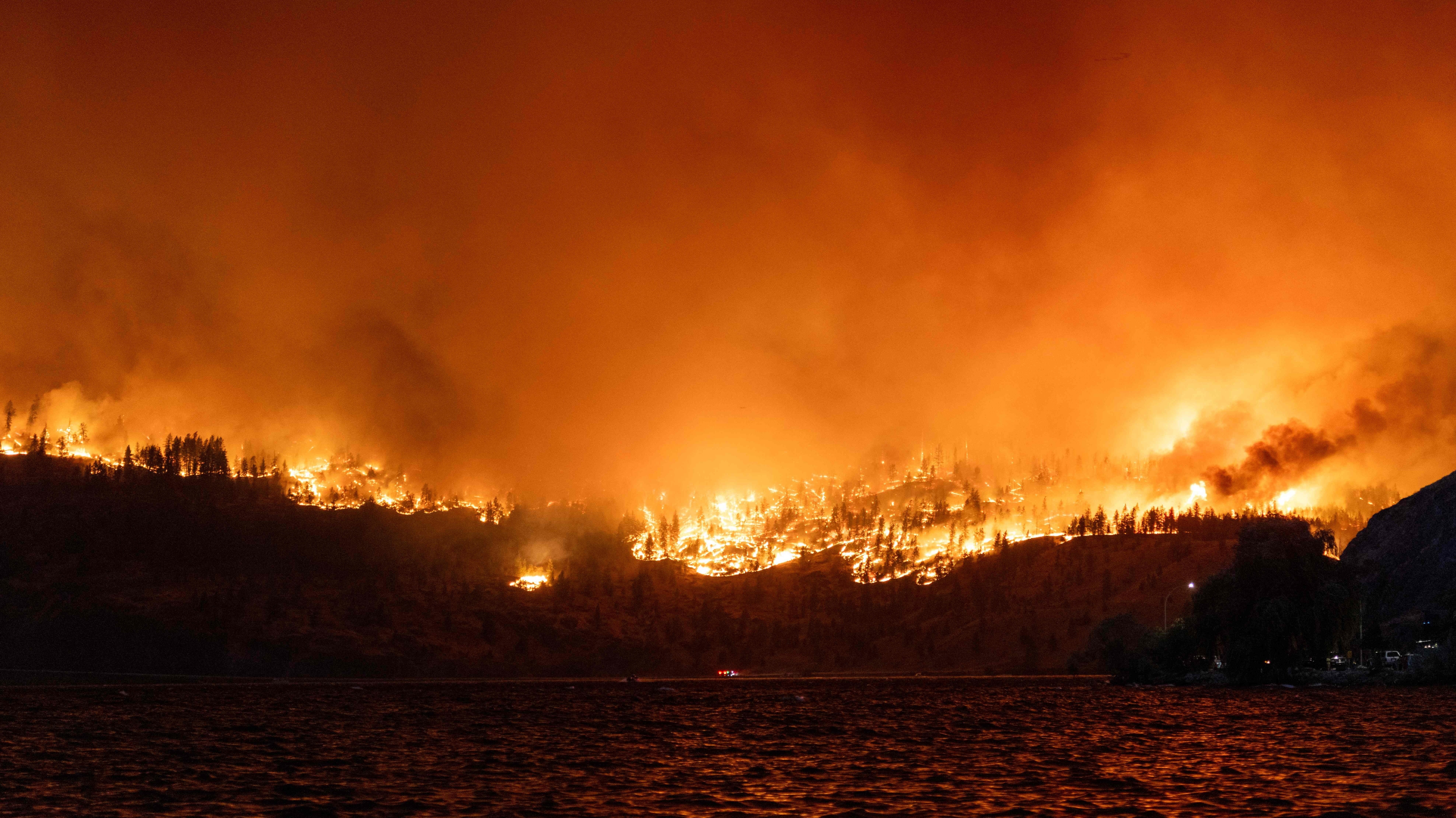 The McDougall Creek wildfire burns in the hills West Kelowna, British Columbia, Canada, on Thursday as seen from Kelowna.