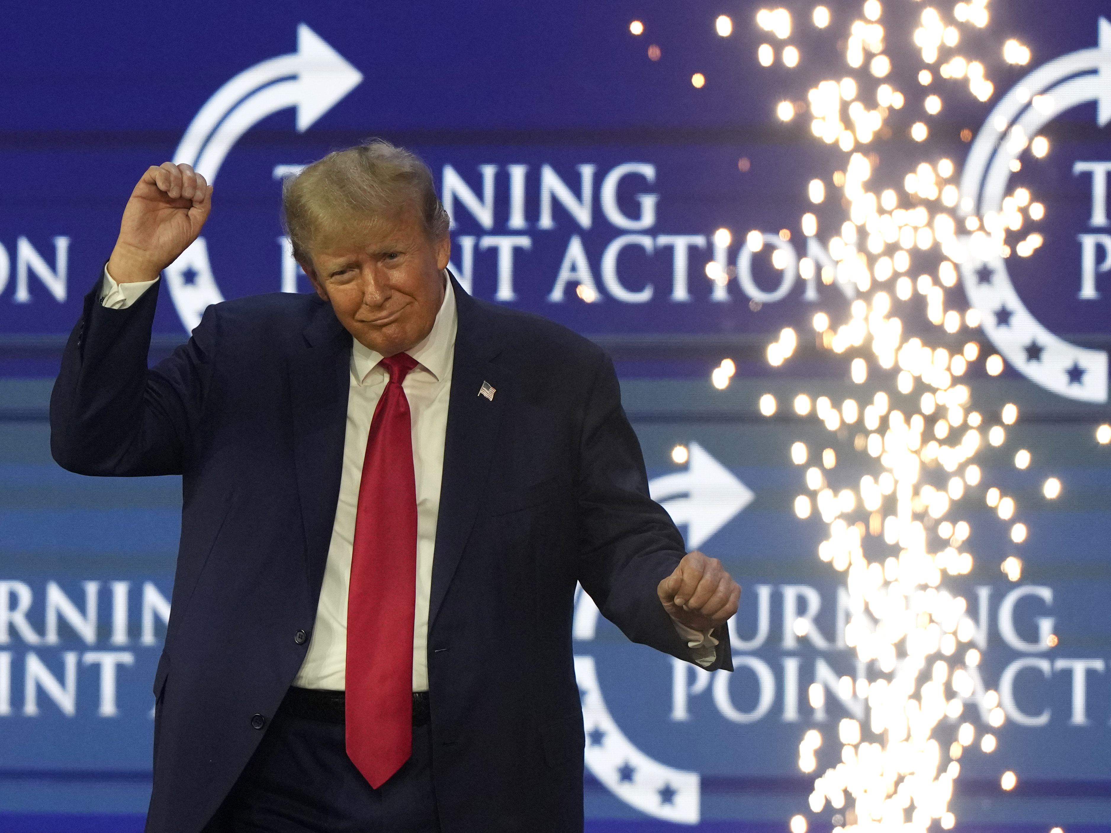 Former President Donald Trump dances on stage at the Turning Point Action conference, Saturday, July 15, in West Palm Beach, Fla.
