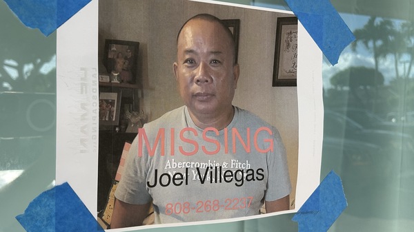 A poster seeking help finding a man not seen after the Lahaina fire is taped to a store window. The official figure of people listed as "not accounted for" has changed drastically this week.