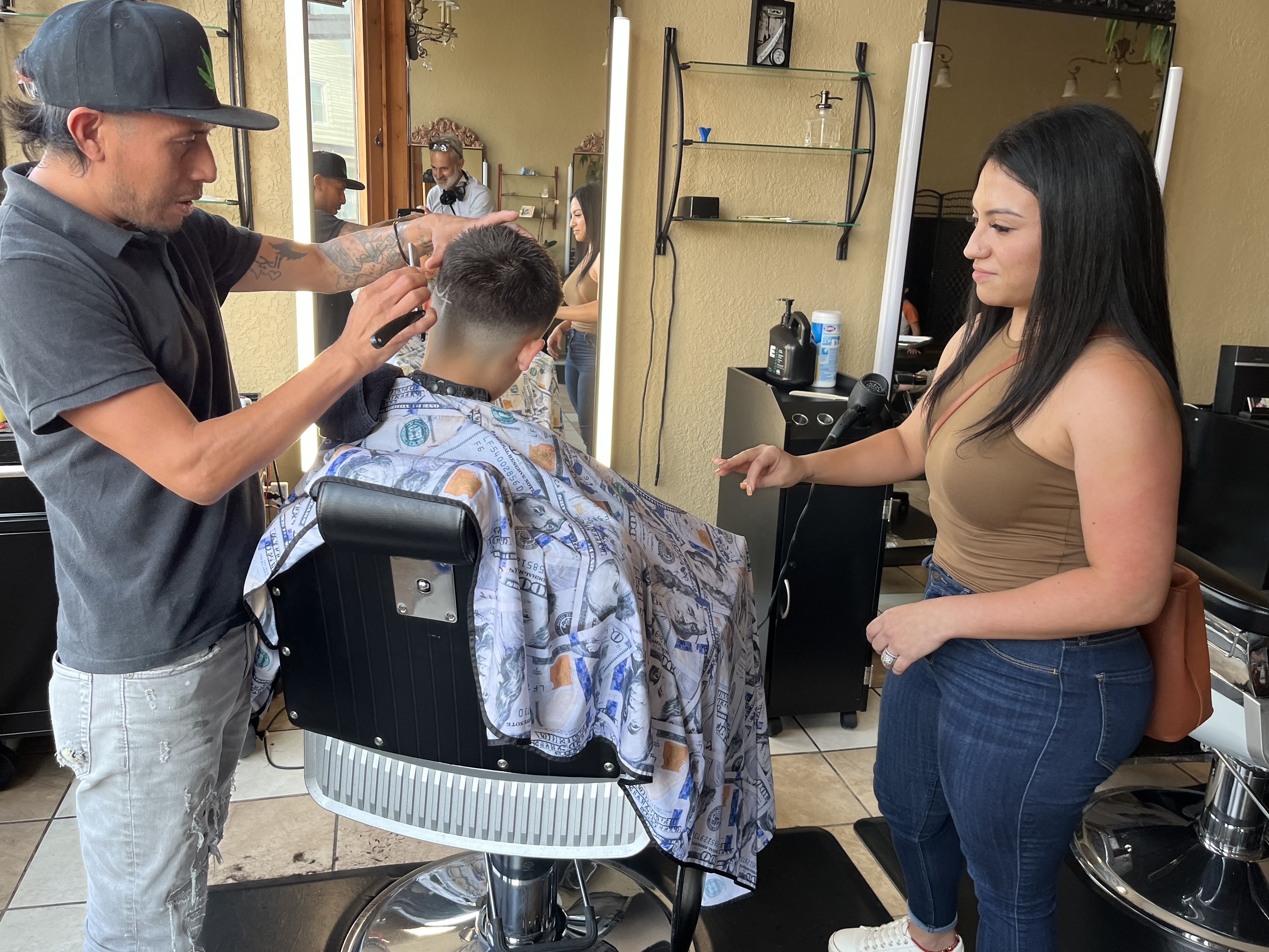 Jennifer Nuno checks her 11-year-old son's back-to-school haircut in the Lincoln Village neighborhood of Milwaukee on August 21. (NPR)