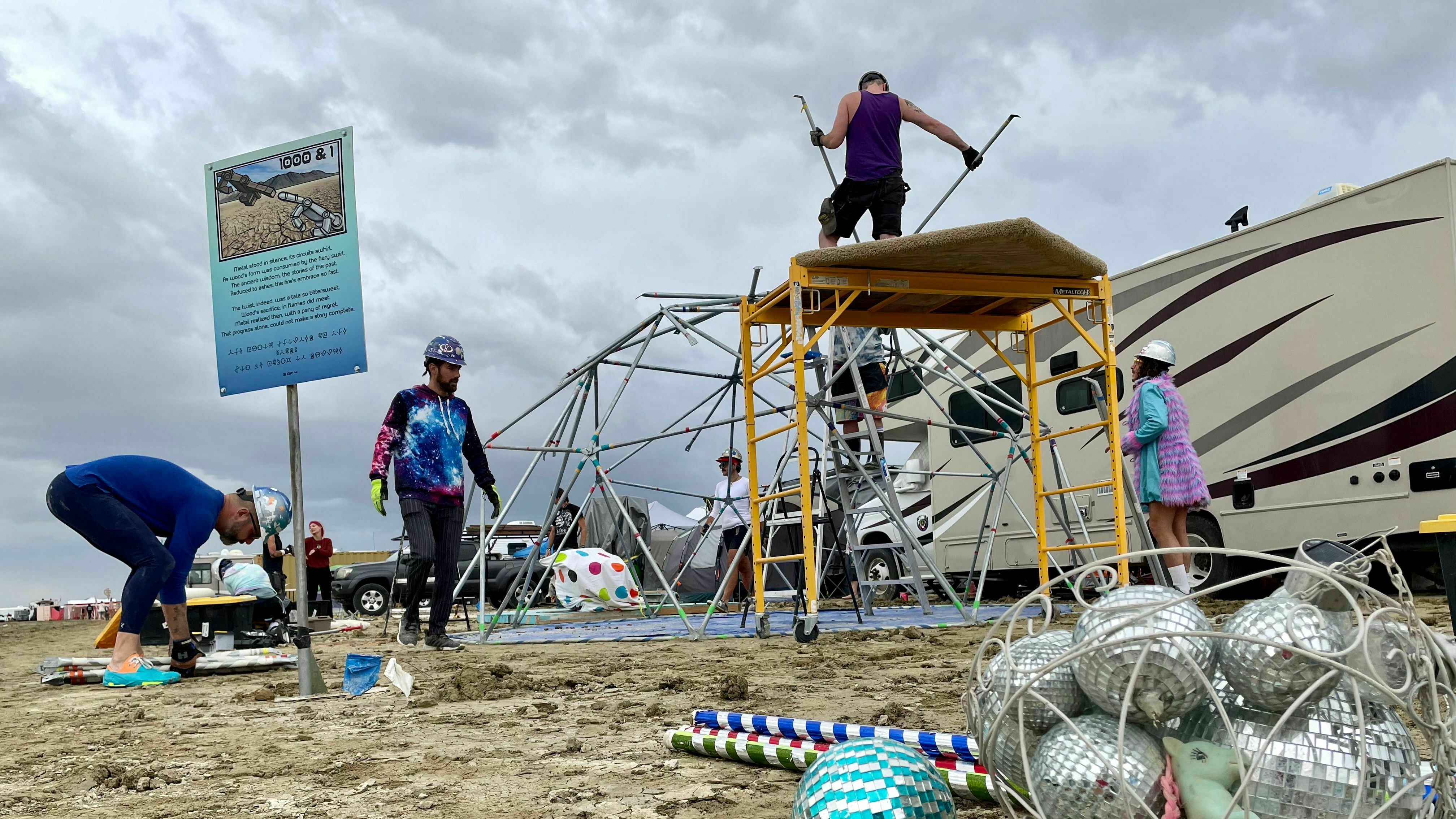 Attendees known as "burners" strike down their camp before new rainfalls in a muddy desert plain on Sunday after heavy rains turned the annual Burning Man festival site in Nevada