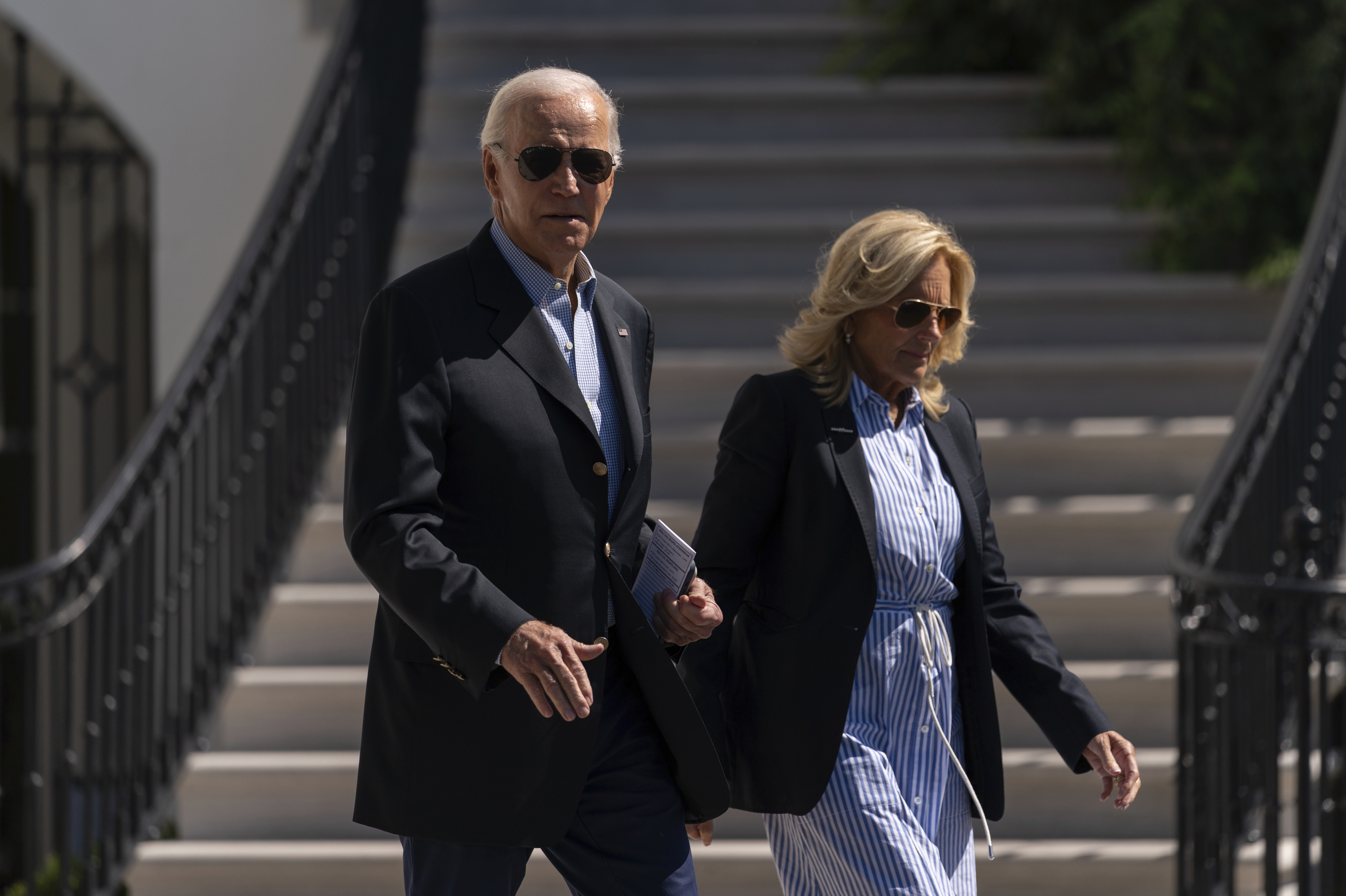 President Joe Biden and first lady Jill Biden walk to board Maine One at the White House in Washington on Saturday en route to Florida.