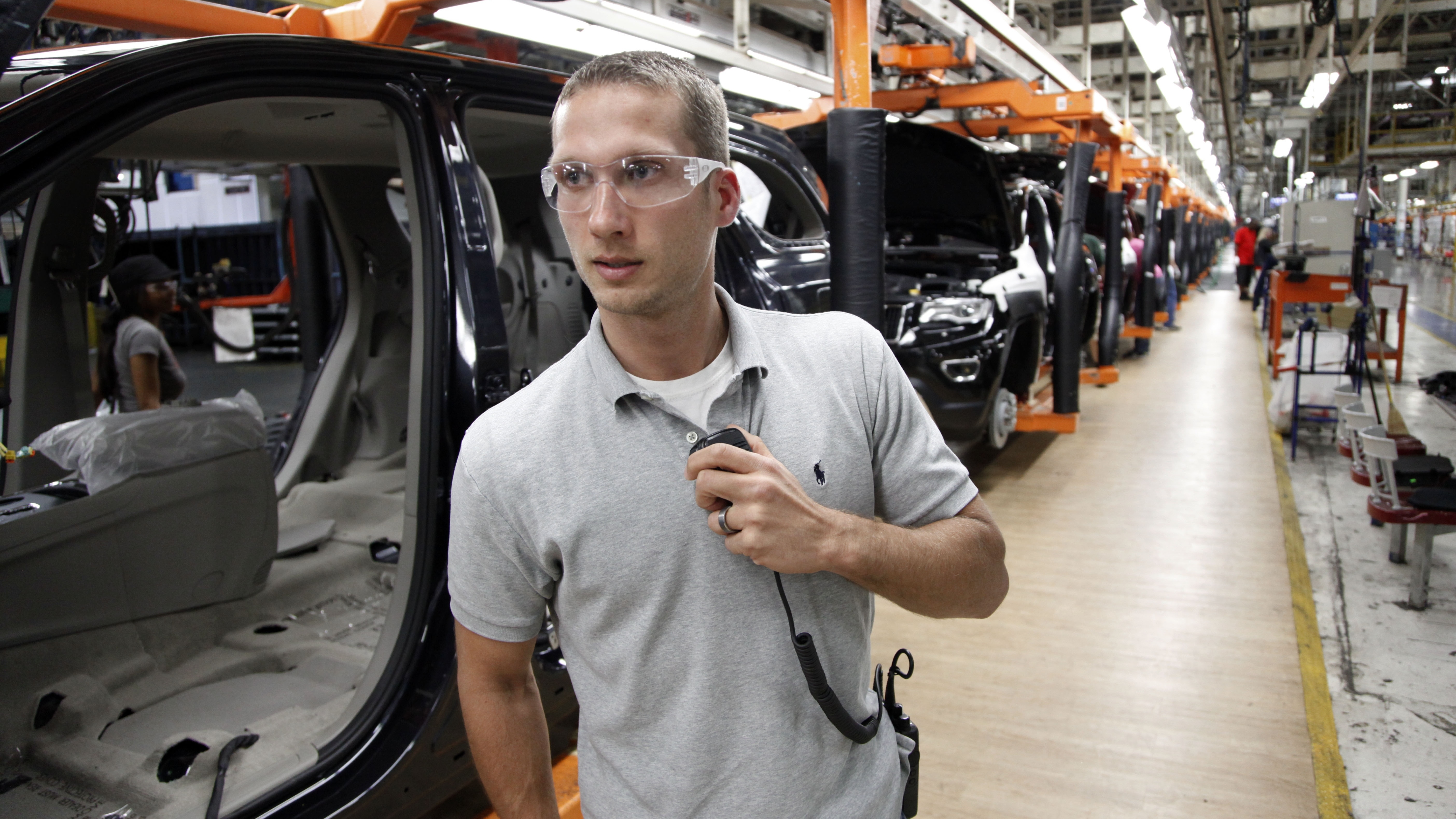 In this Wednesday, May 8, 2013 photo, Jeff Caldwell, 29, a chassis assembly line supervisor, monitors the assembly line at the Chrysler Jefferson North Assembly plant in Detroit.