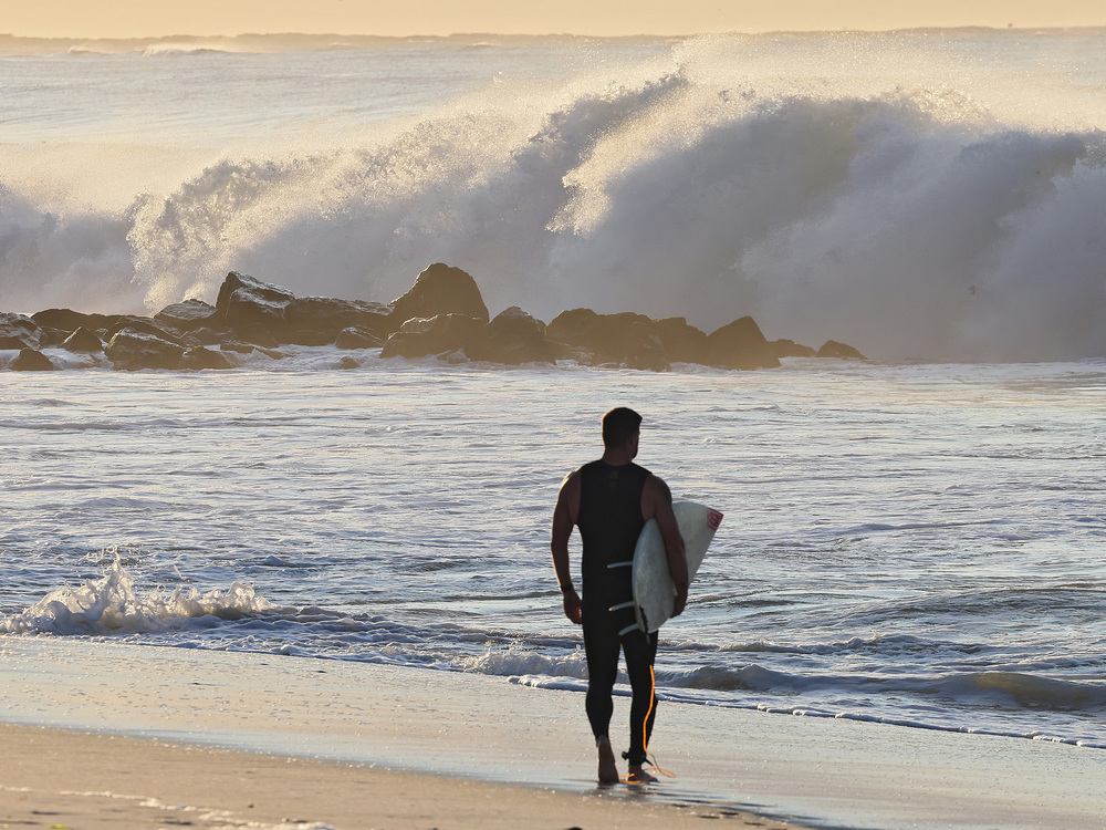A surfer watches higher than normal waves crash ashore in Lido Beach, N.Y. on Thursday, Sept. 14, 2023. Long Island beaches witnessed 8 to 10-foot waves as Hurricane Lee moved toward the New England area. (Getty Images)