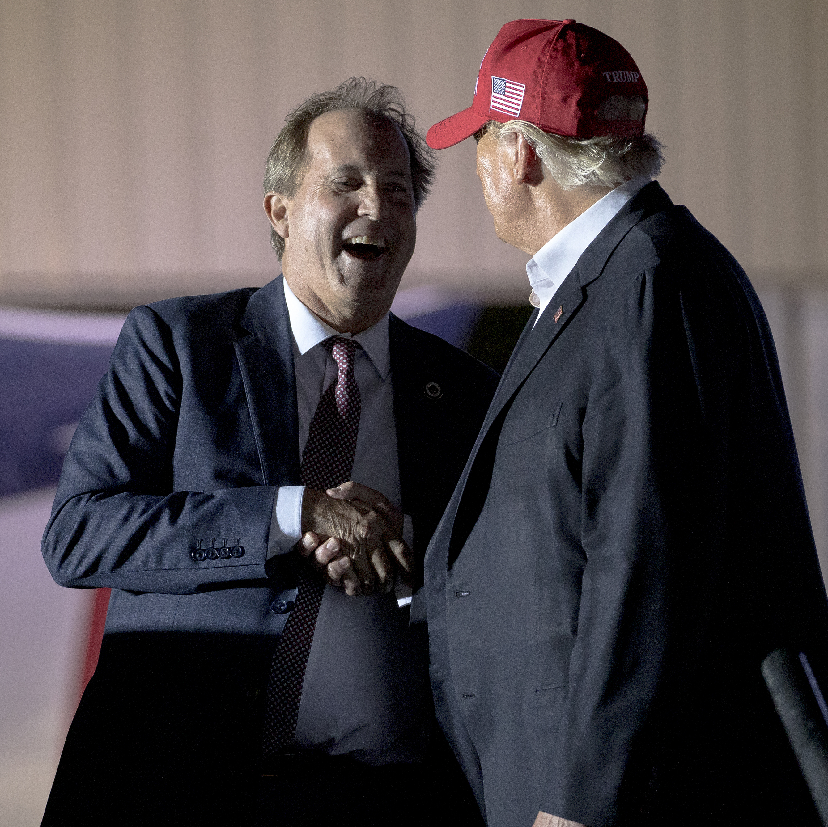 Former President Donald Trump (right) shakes hands with Texas Attorney General Ken Paxton at an October 2022 rally in Robstown, Texas.