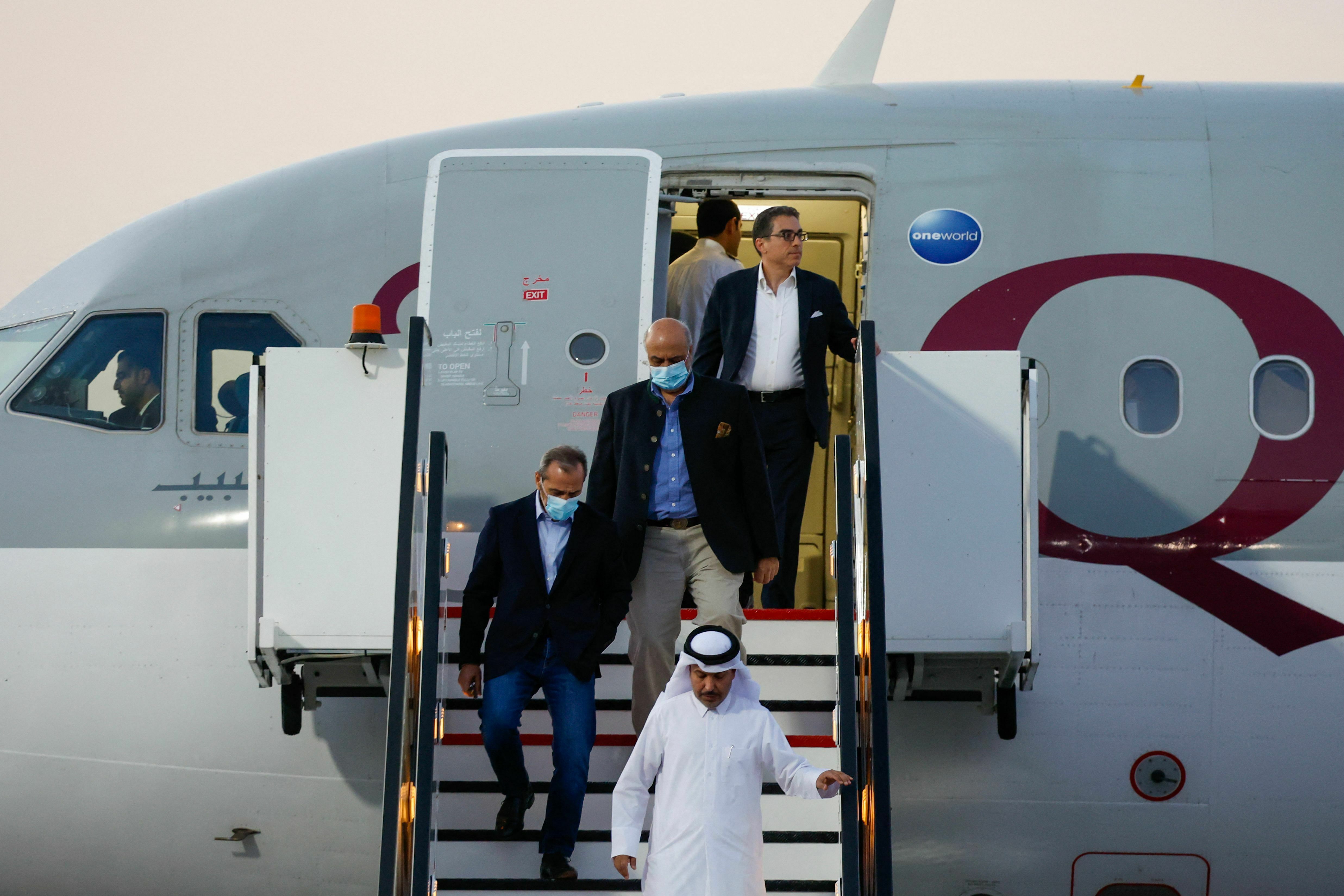 U.S. citizens Siamak Namazi (back), Emad Sharqi (left) and Morad Tahbaz (center) disembark from a Qatari jet on their arrival at the Doha International Airport on Monday. (AFP via Getty Images)