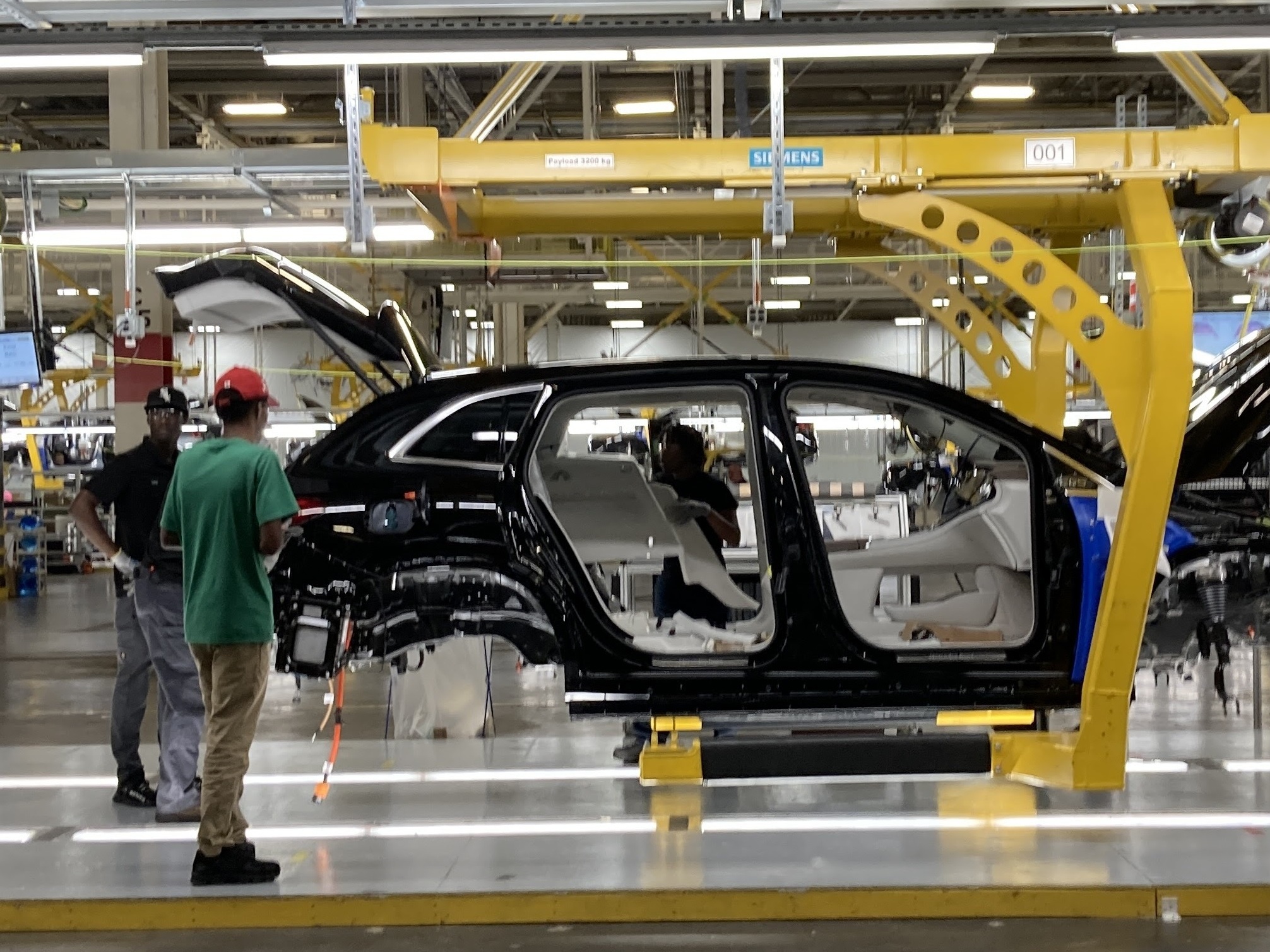 Autoworkers at Mercedes plant in Vance, Ala., assemble an all-electric SUV. (Gulf States Newsroom)