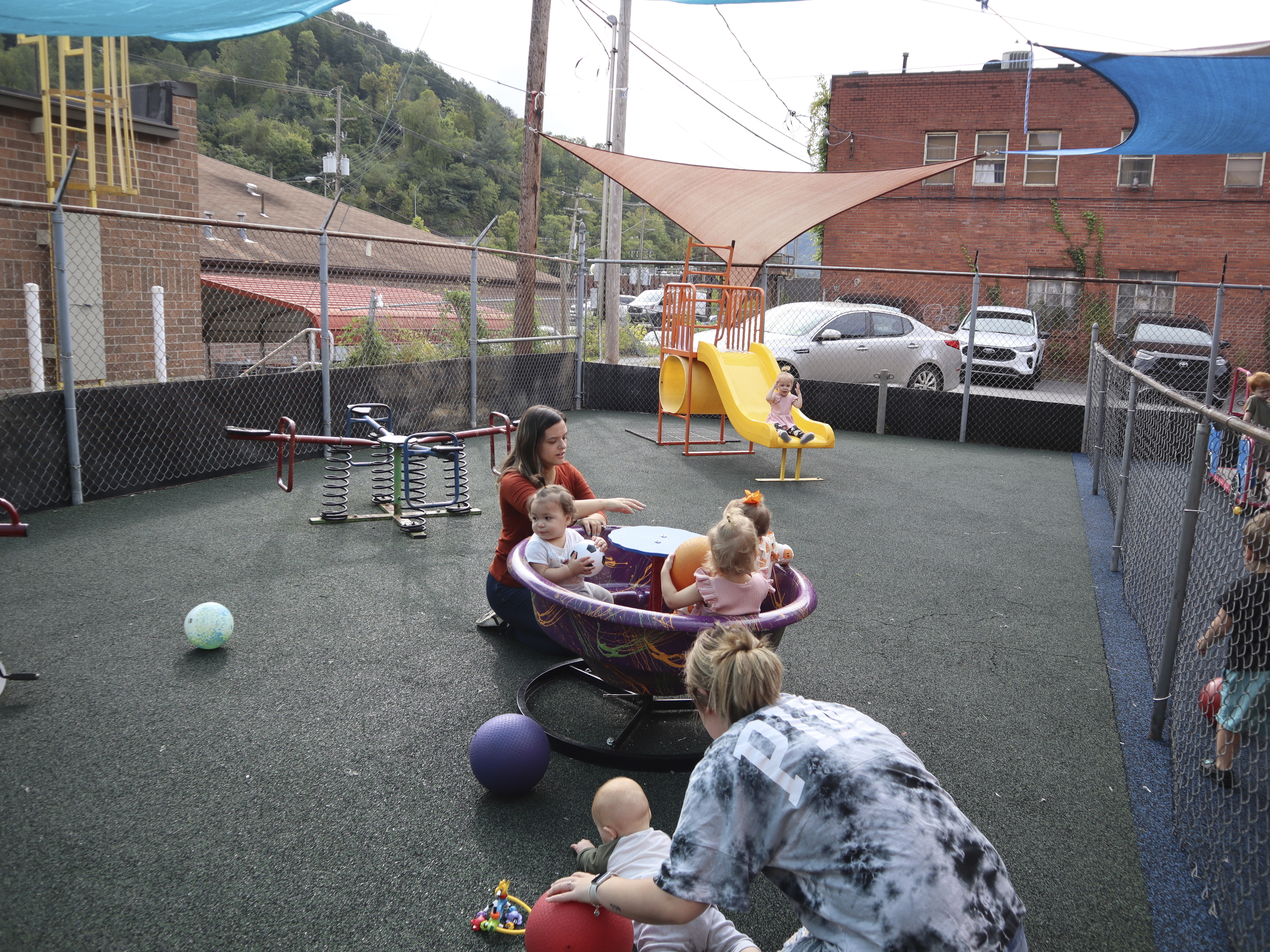 Staff and toddlers play at a daycare in Williamson, W.Va. in September.