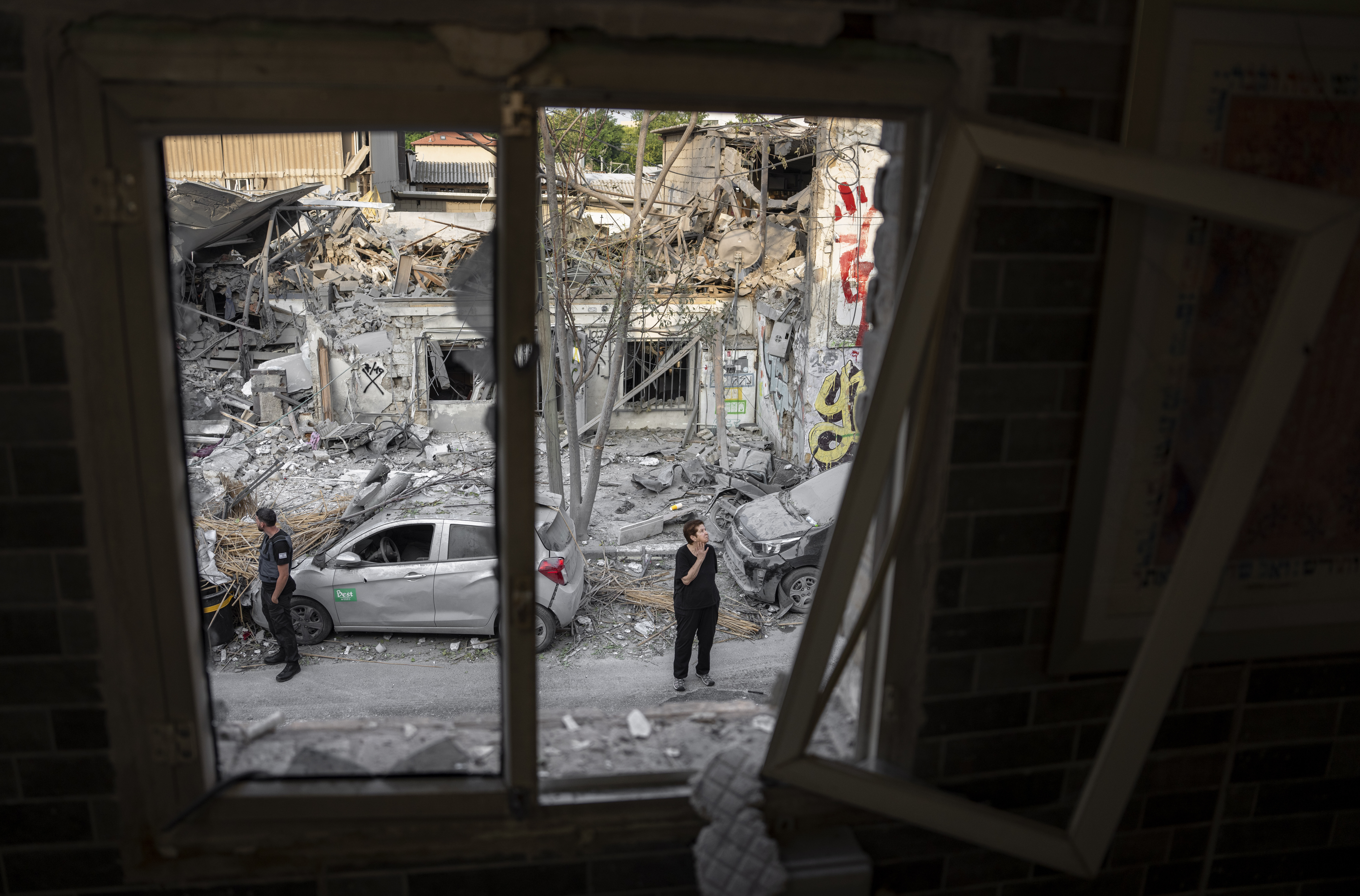 Sun., Oct. 8: Israelis inspect the rubble of a building a day after it was hit by a rocket fired from the Gaza Strip, in Tel Aviv, Israel.