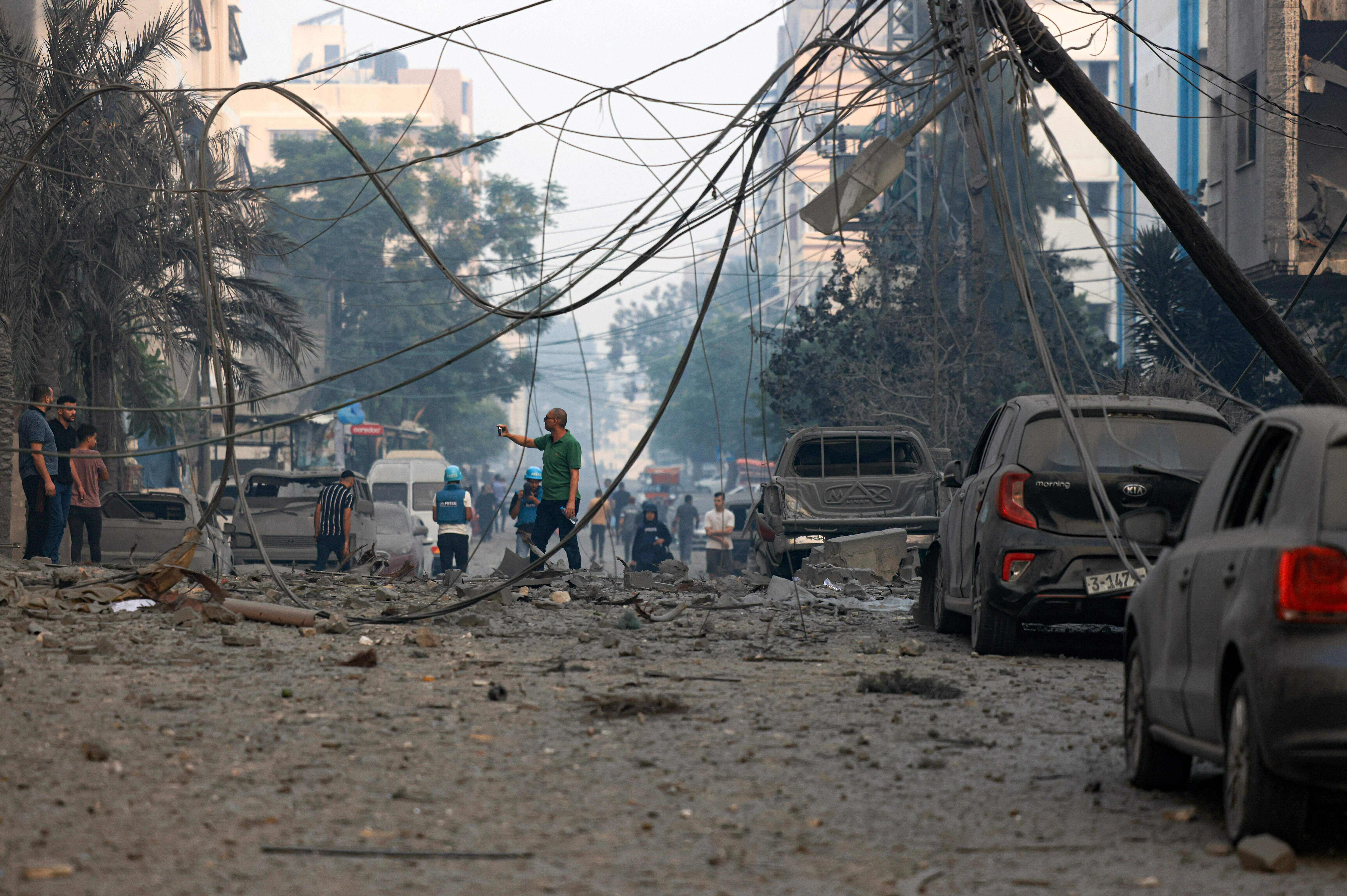 Sun., Oct. 8: Residents check the damage following Israeli air strikes in Gaza City.