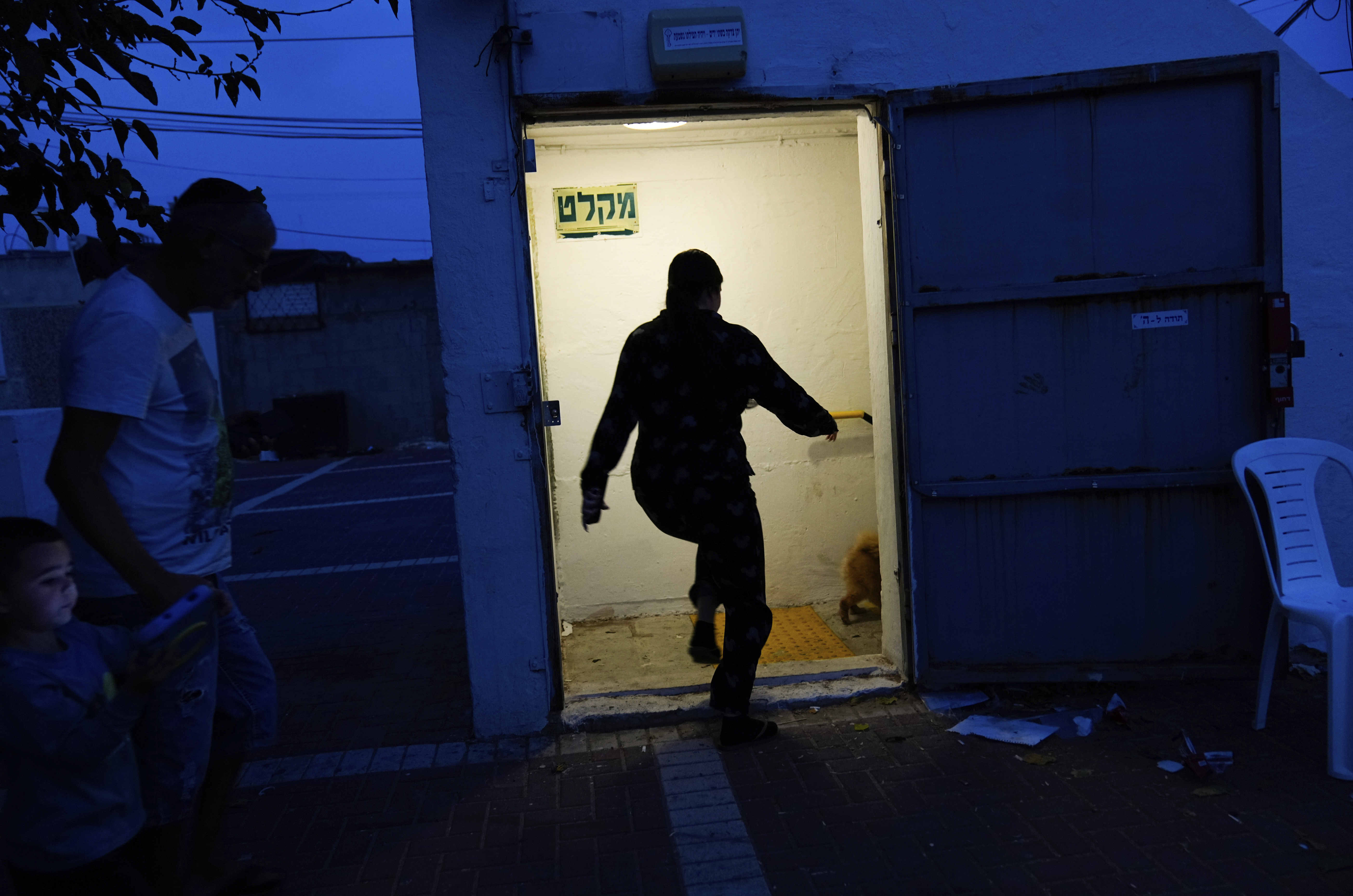 Sun., Oct. 8: Israelis run to take cover in a shelter as a siren sounds a warning of incoming rockets fired from the Gaza strip, in Ashkelon, Israe