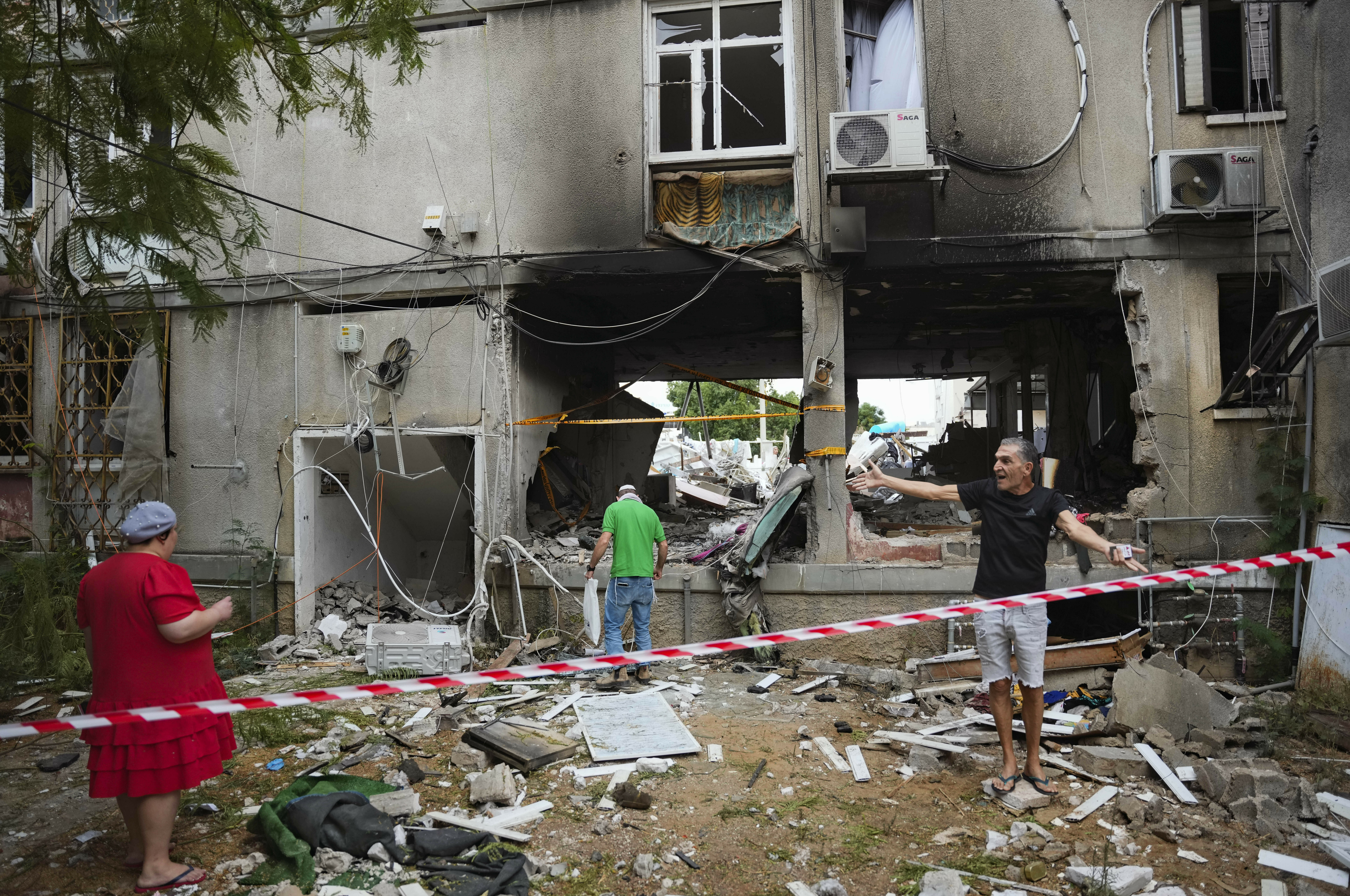 Mon., Oct. 9: Israelis inspect a damaged residential building after it was hit by a rocket fired from the Gaza Strip, in Ashkelon, Israel.