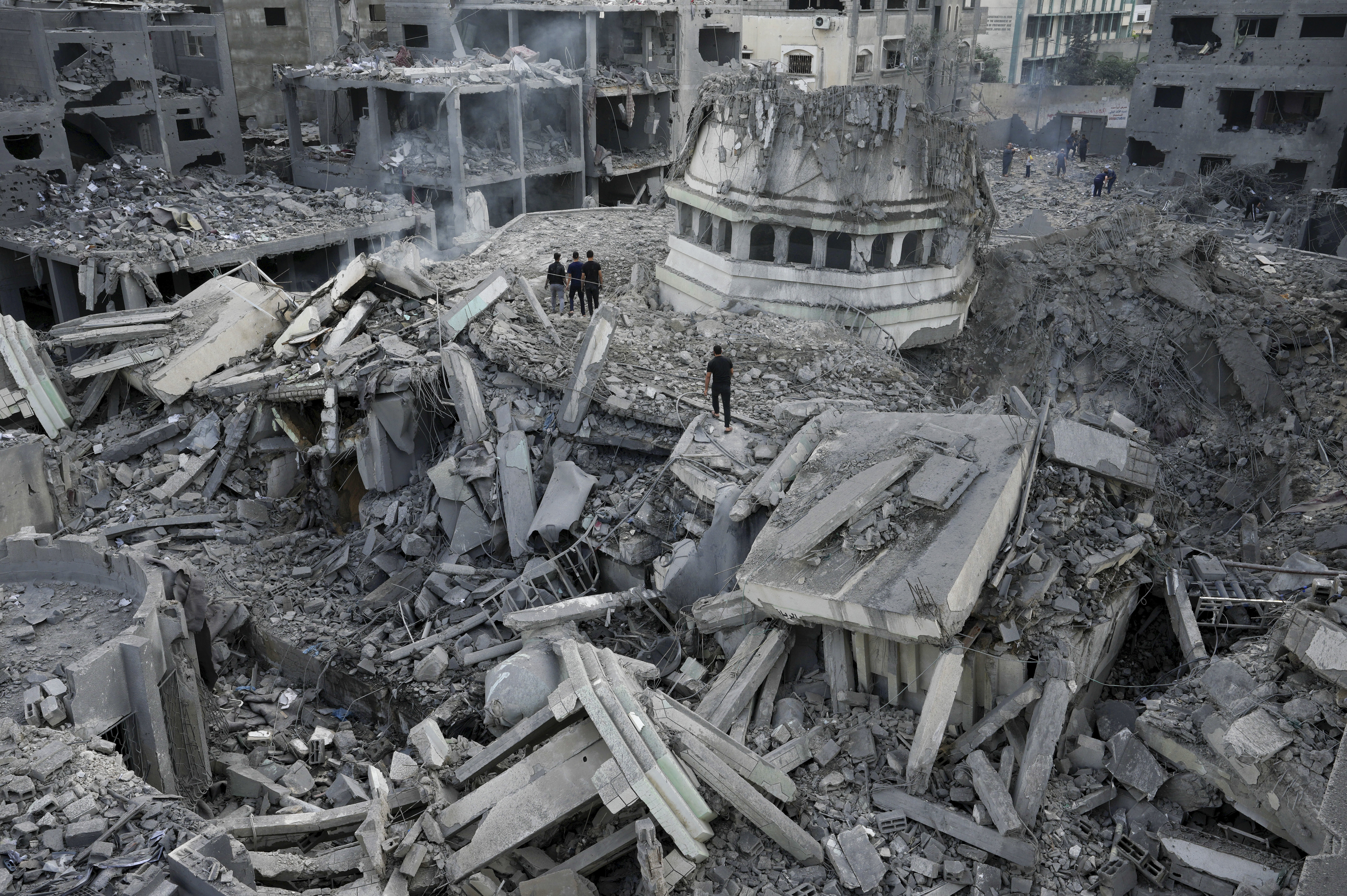 Mon., Oct. 9: Palestinians inspect the rubble of the Yassin Mosque destroyed after it was hit by an Israeli airstrike at Shati refugee camp in Gaza City.