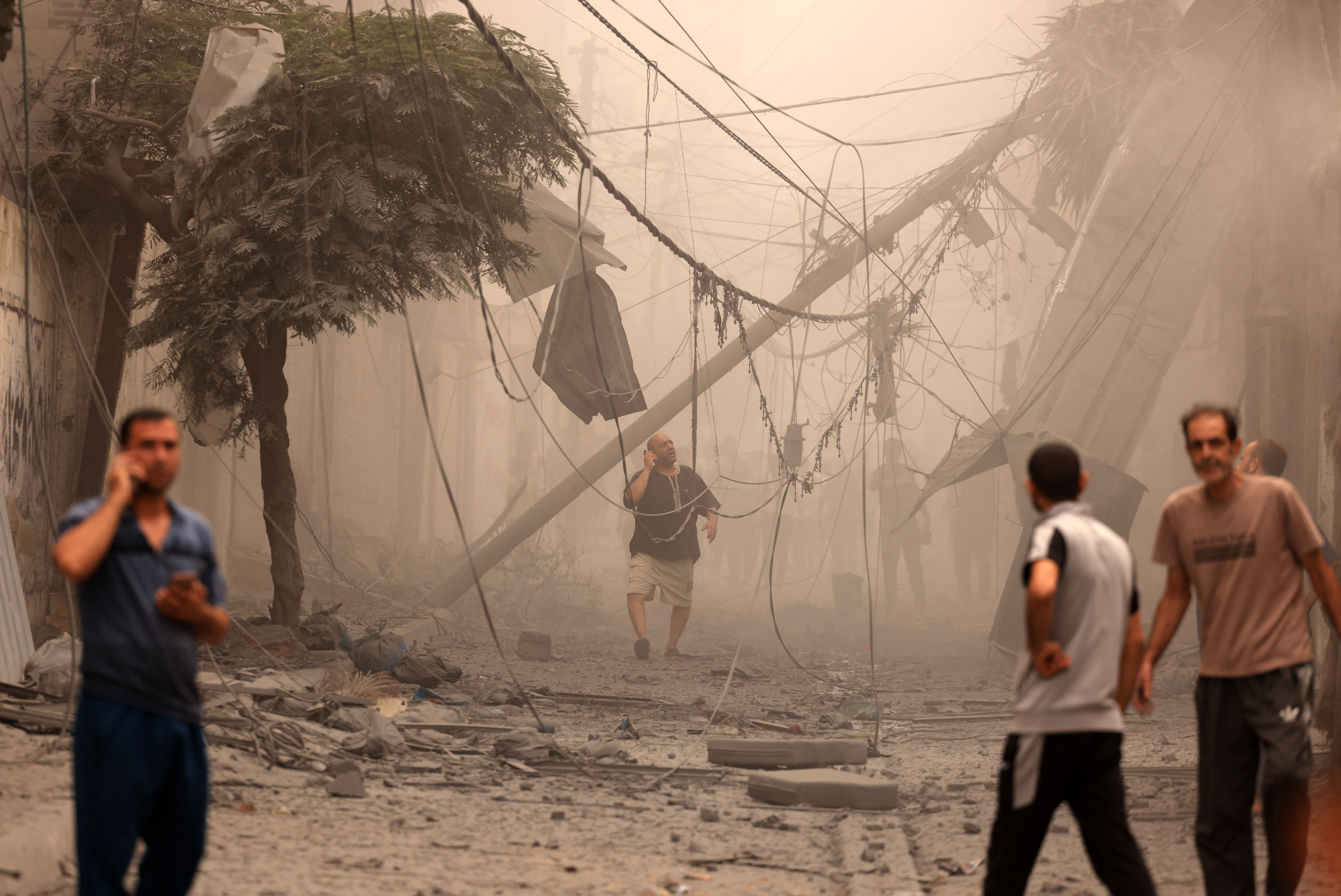 Mon., Oct. 9: Palestinians inspect the destruction in a neighborhood heavily damaged by Israeli airstrikes on Gaza City's Shati refugee camp.