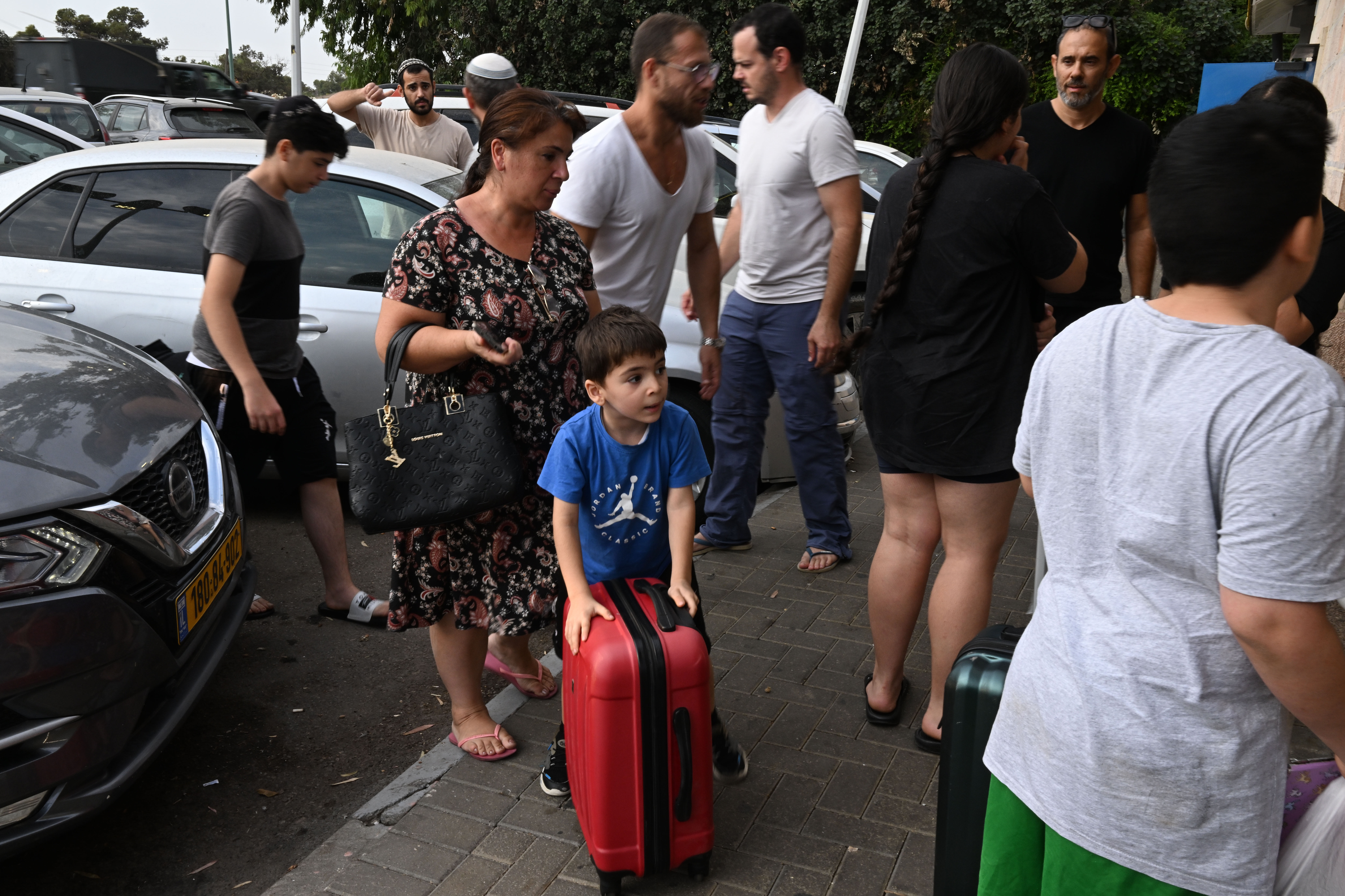 A family of survivors is taken by volunteer drivers from their home. (Tanya Habjouqa/NOOR for NPR)