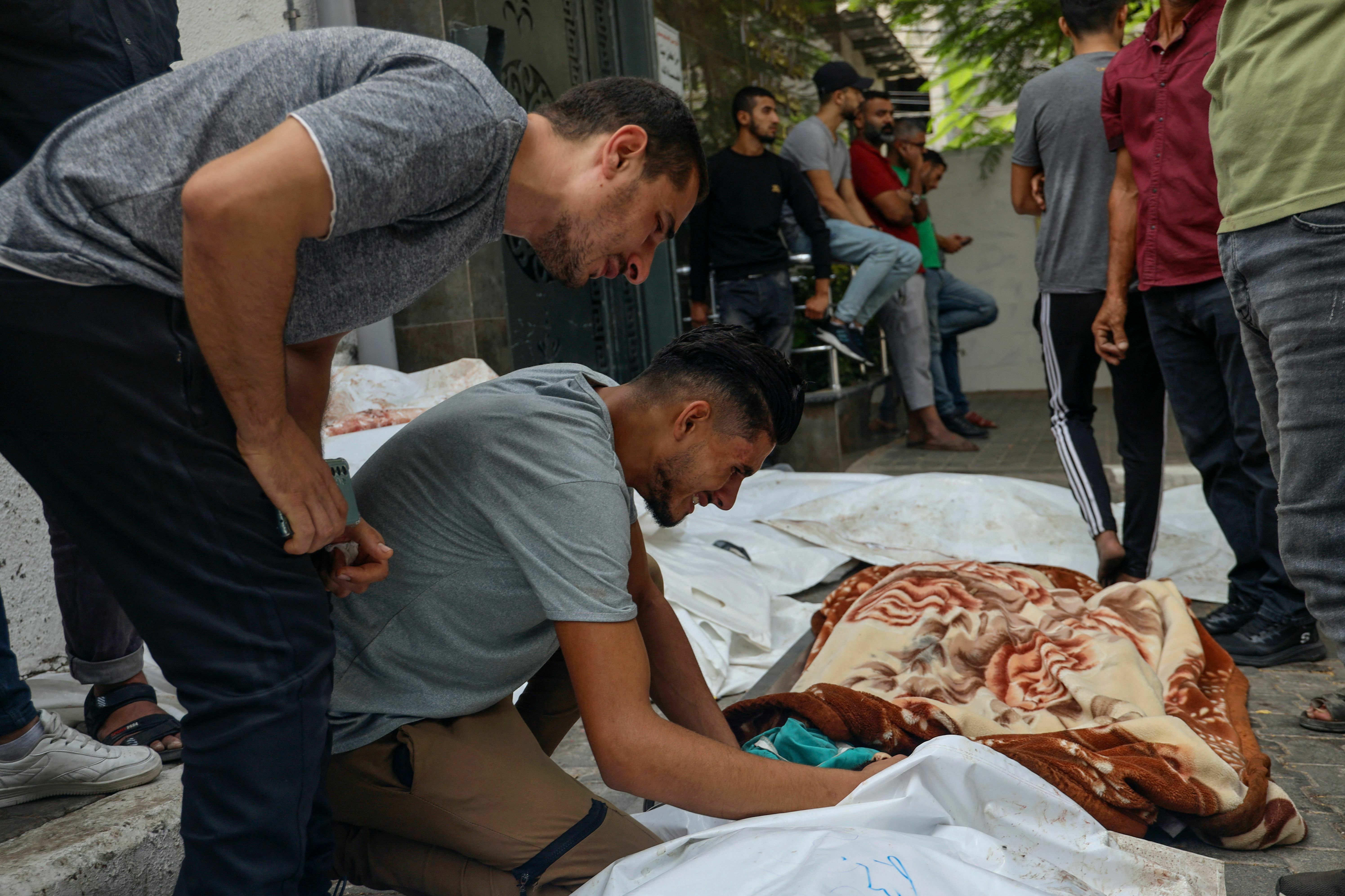 Tues., Oct. 10: Palestinians mourn next to the body of a victim killed in Israeli shelling, during a mass funeral in Gaza City.