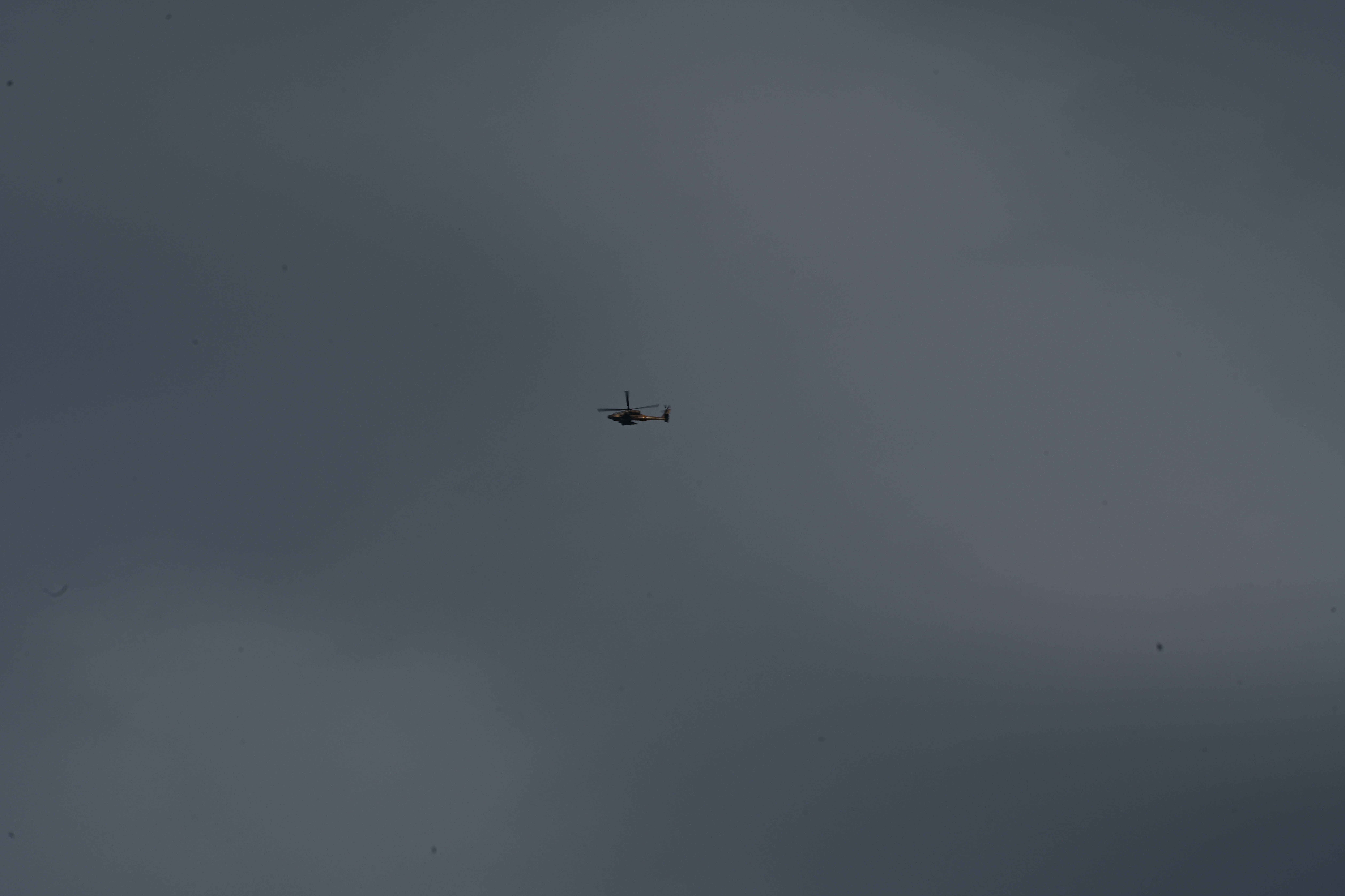 At a rest stop near Hamas attack sites, Israelis rush to help families and soldiers 6 An Israeli military helicopter flies above the highway rest stop at Beit Kama Junction.