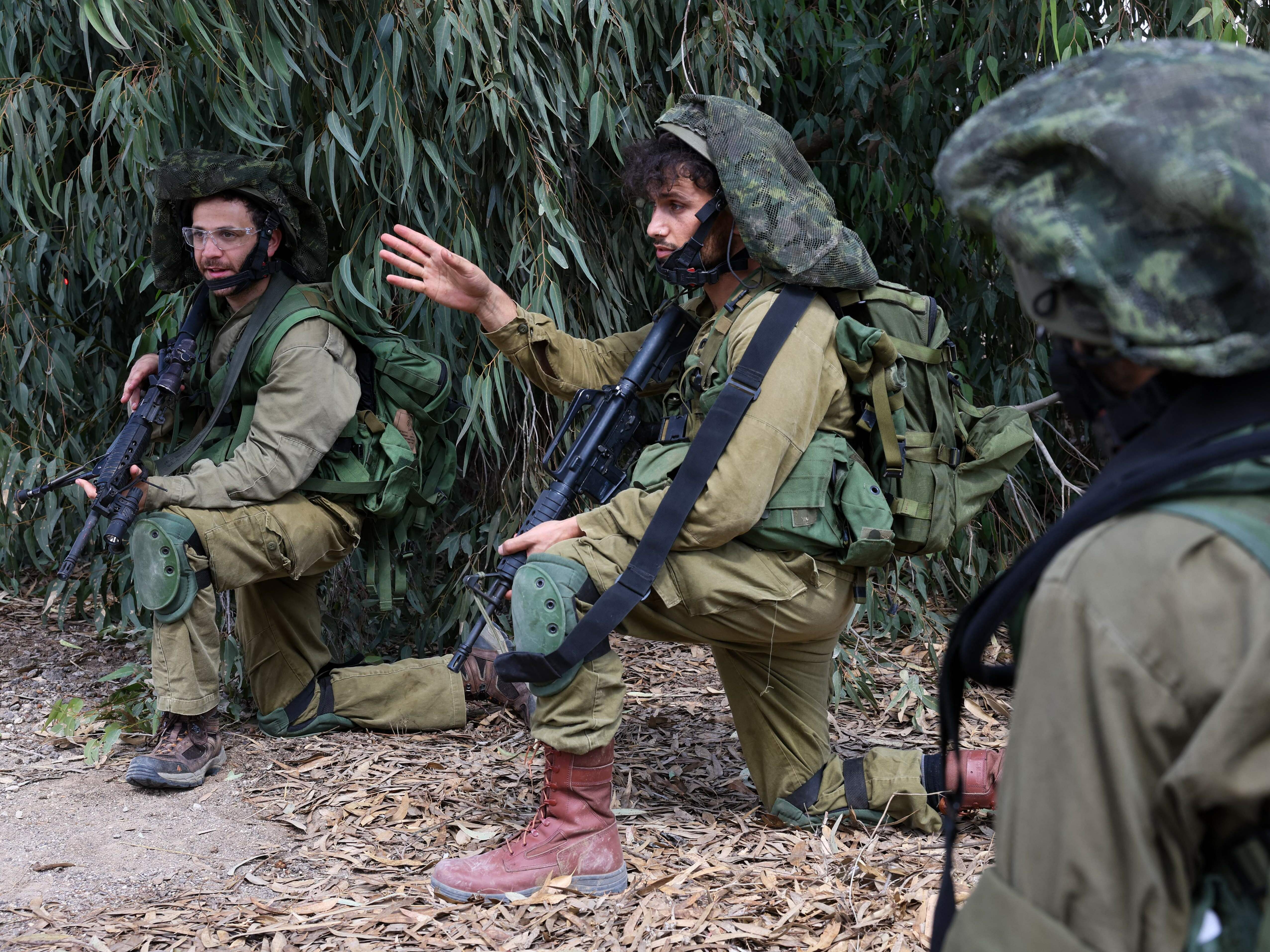 Israeli soldiers take up position in Kfar Aza, in the south of Israel, bordering Gaza Strip on Tuesday, Oct. 10, 2023. (AFP via Getty Images)